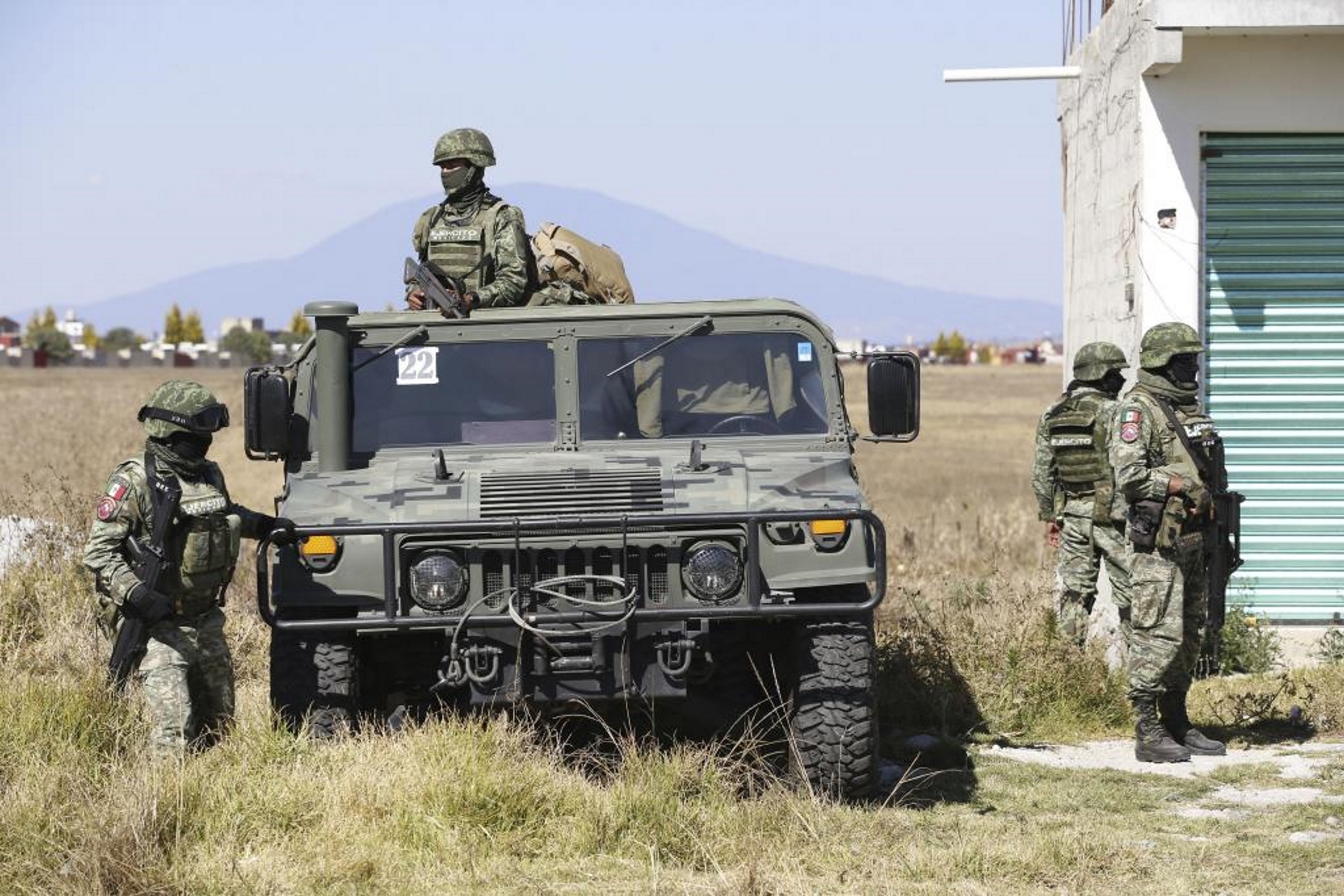 Military officers guard a checkpoint near the prison where Chapo Guzmans son is being held.