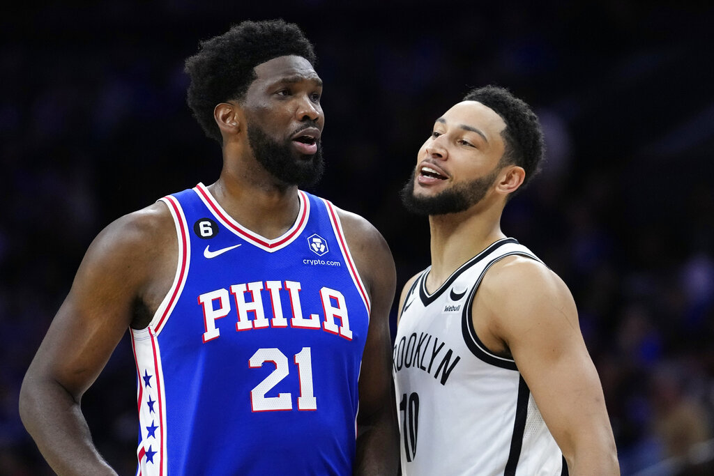 Philadelphia 76ers Joel Embiid, left, and Brooklyn Nets Ben Simmons talk before the second half of the game.