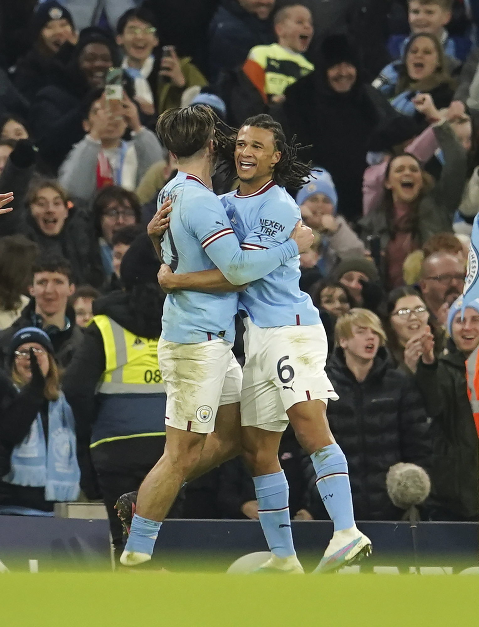 Manchester Citys Nathan Ake, right, celebrates with his teammate Jack Grealish after scoring