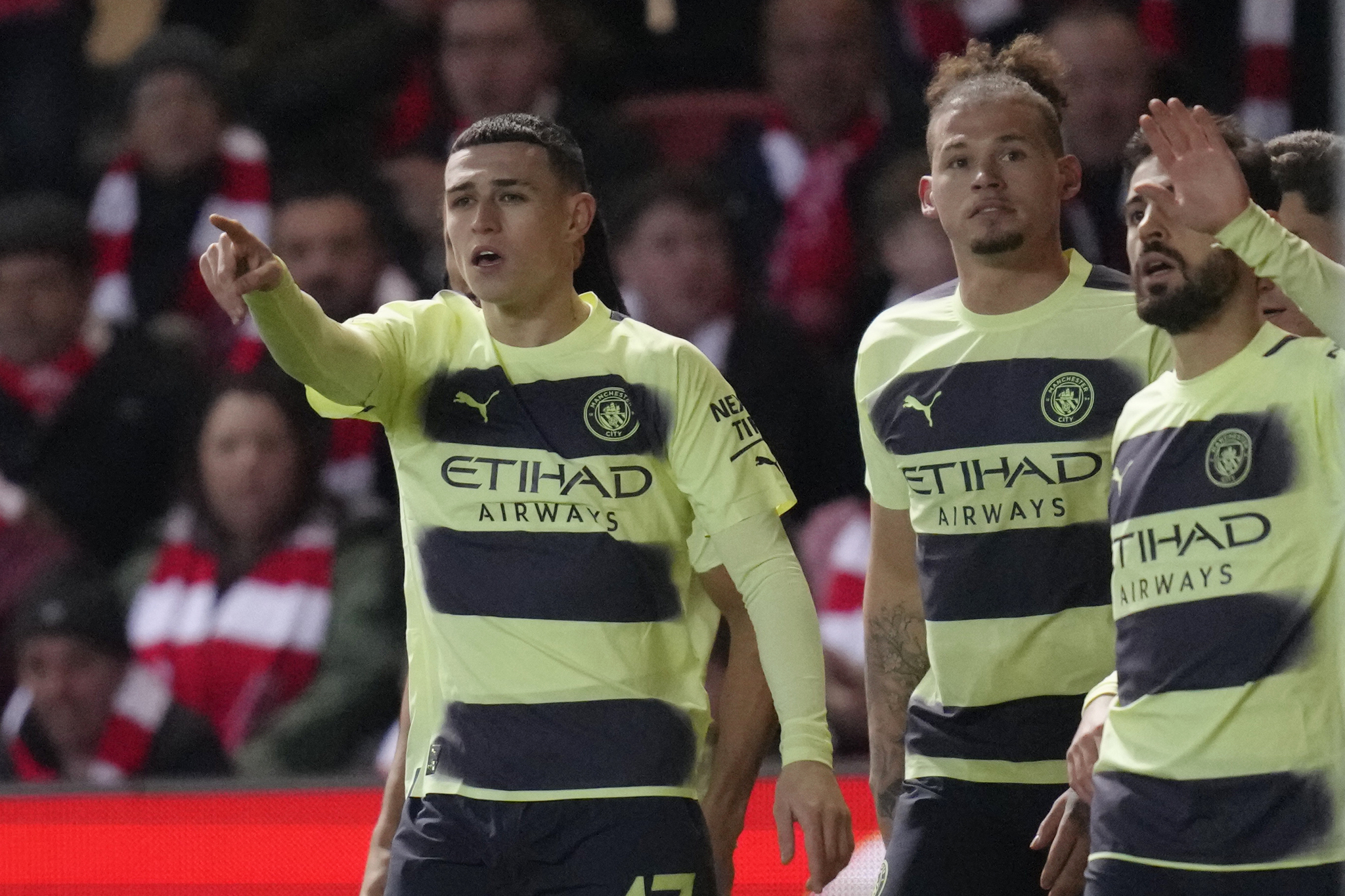 Manchester Citys Phil Foden, left, celebrates with his teammates after scoring