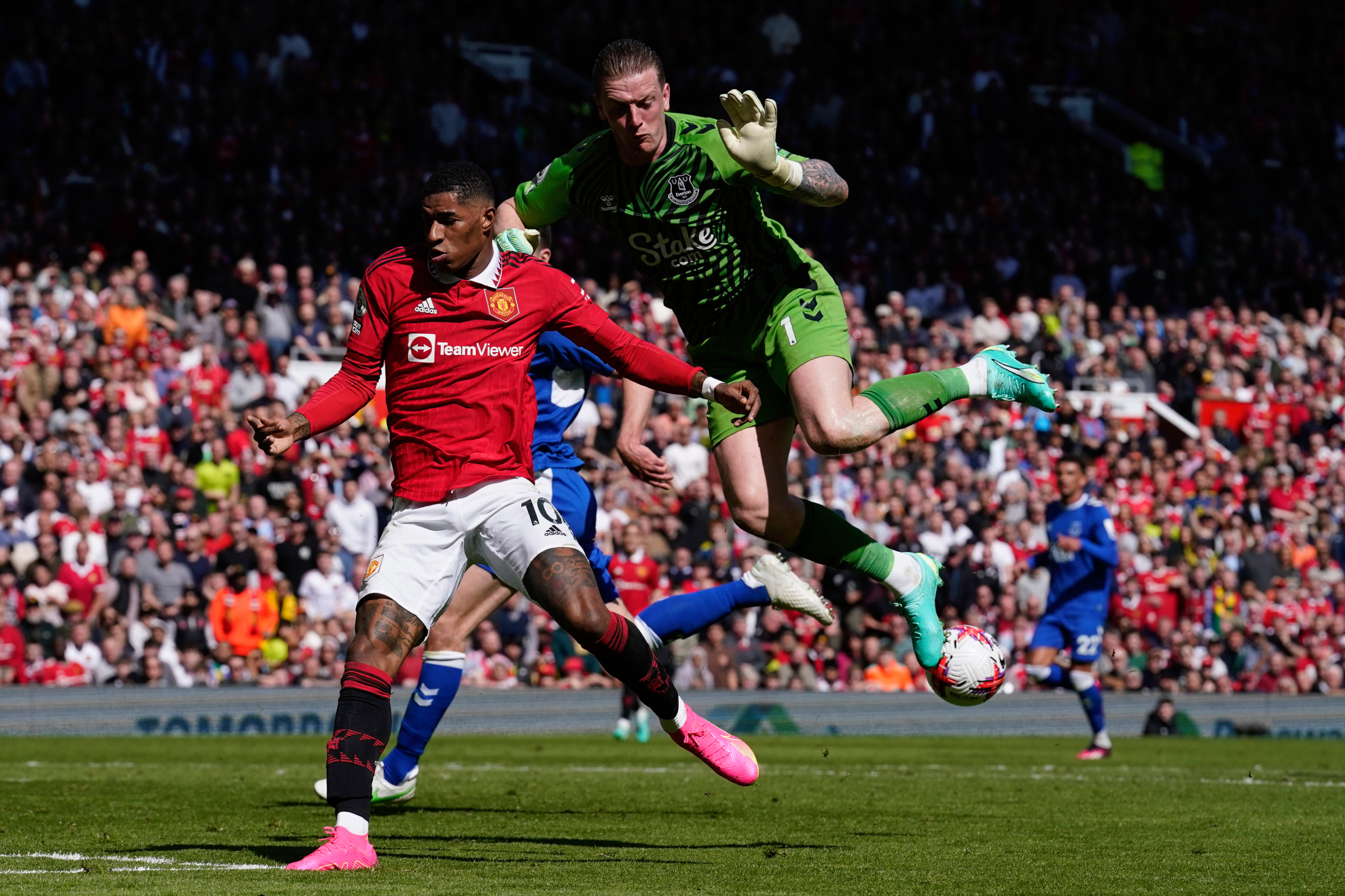 Evertons goalkeeper Jordan Pickford saves on an attempt to score by Manchester Uniteds Marcus Rashford .