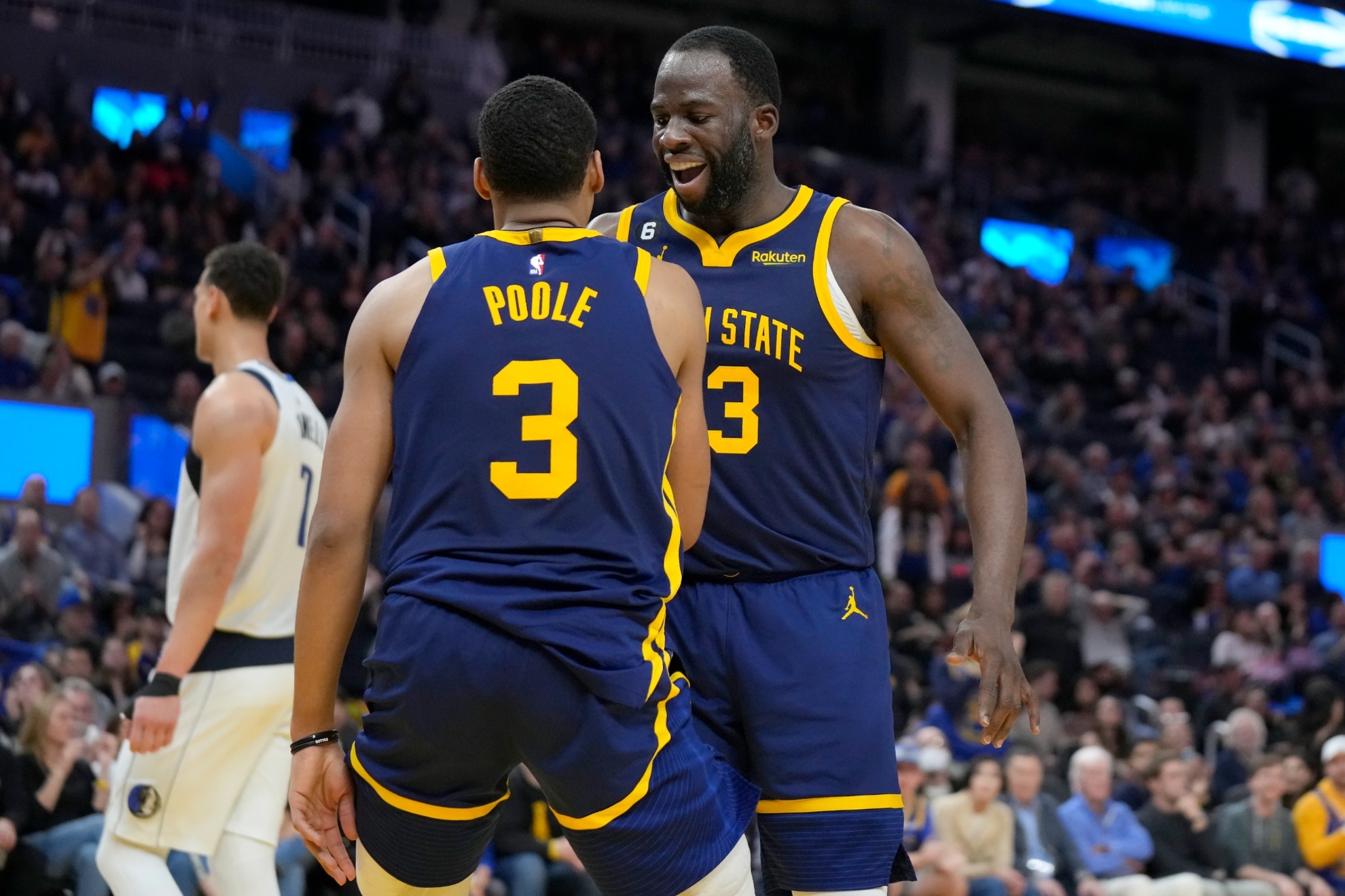 Jordan Poole (3) and Draymond Green, Warriors teammates.
