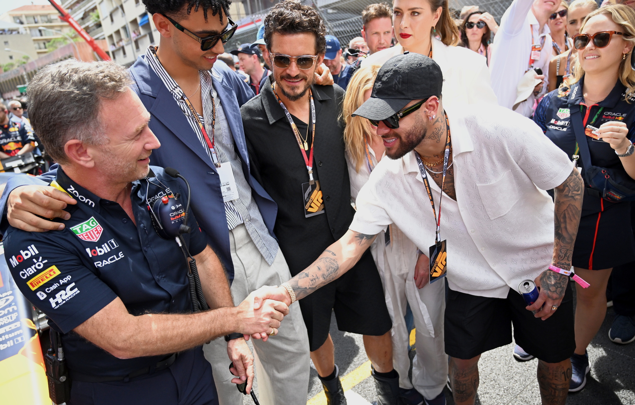 Red Bull boss Christian Horner (L) shakes hands with Neymar (R) of Brazil, as actor Archie Madekwe (2-nd L) ,Orlando Bloom (C), and tennis star Maria Sharapova (behind Neymar)