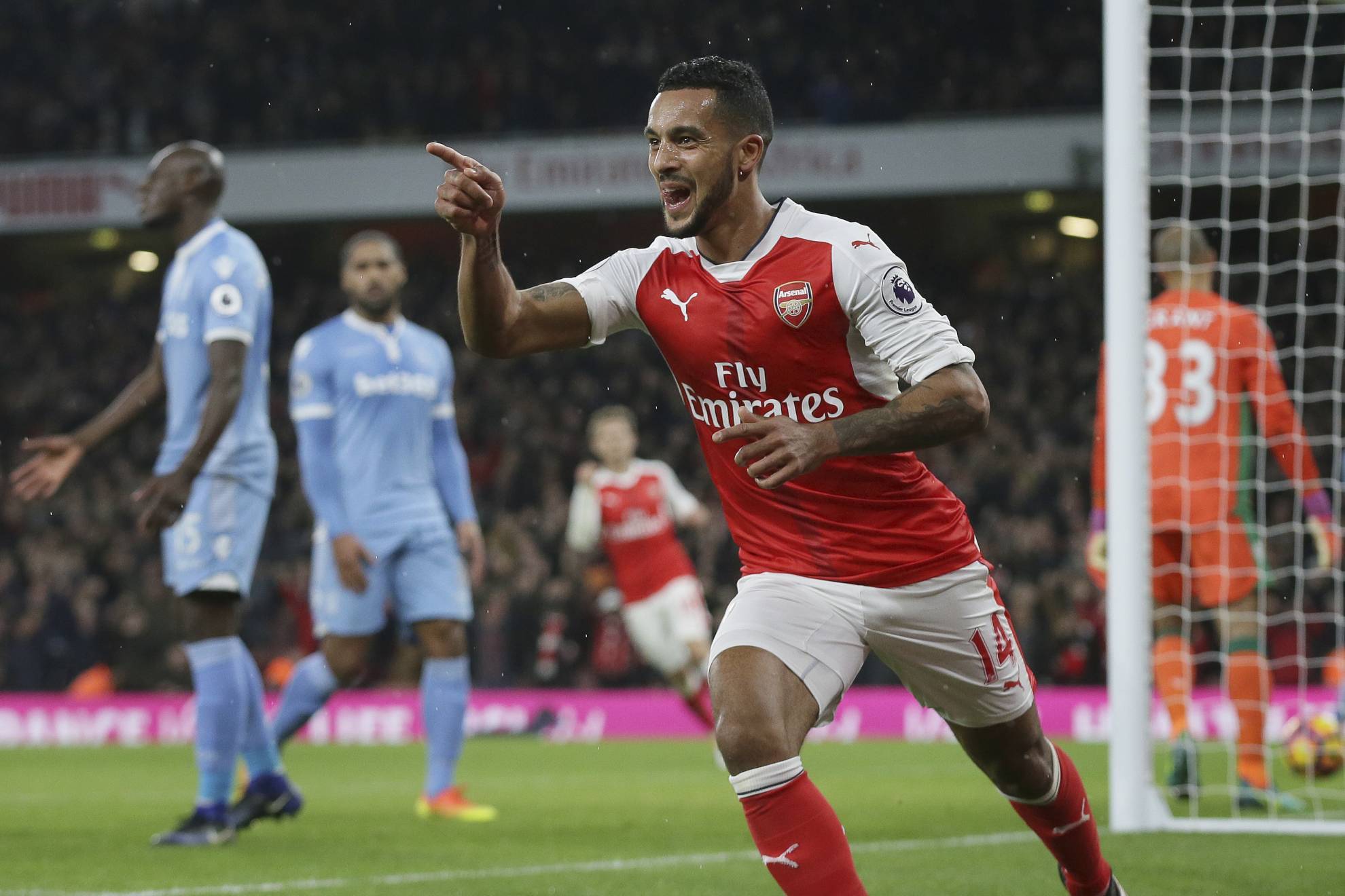 Theo Walcott celebrates after scoring a goal during a Premier League soccer match