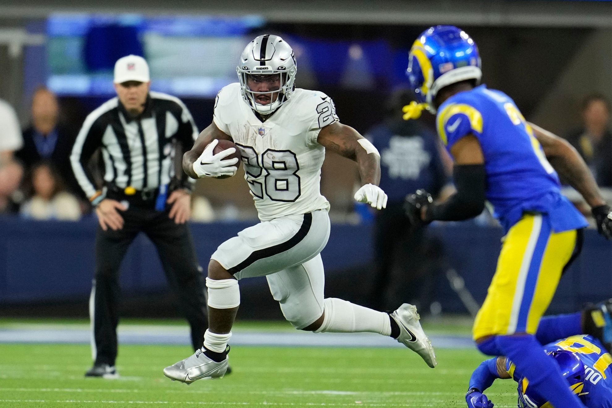 Las Vegas Raiders running back Josh Jacobs runs with the ball during the first half of an NFL football game against the Los Angeles Rams, Thursday, Dec. 8, 2022, in Inglewood, Calif.