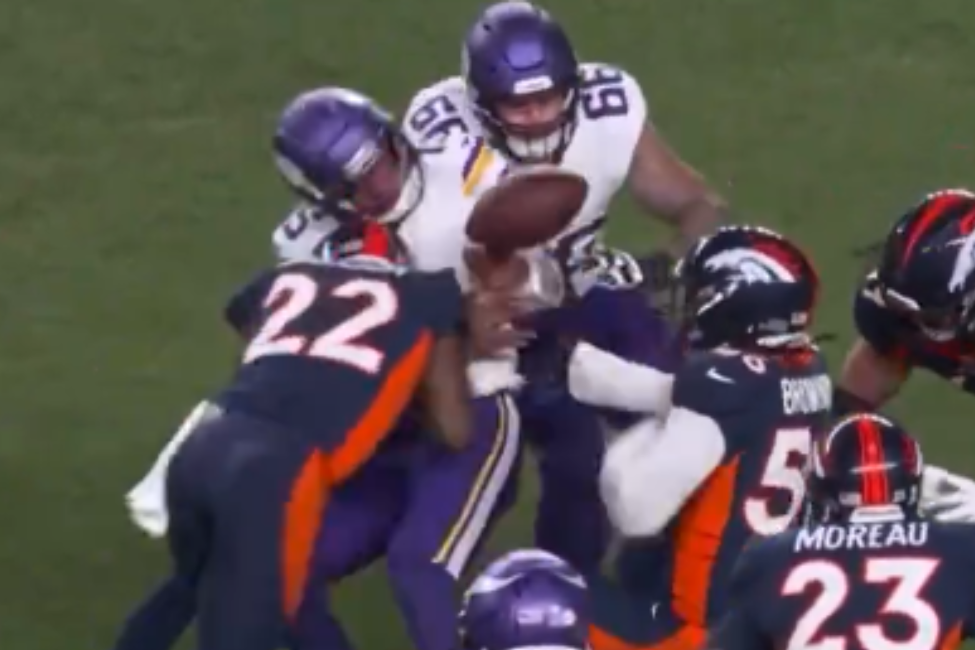 Jackson (22 in blue) leads with his helmet while attempting to bring down Dobbs (15 in white).