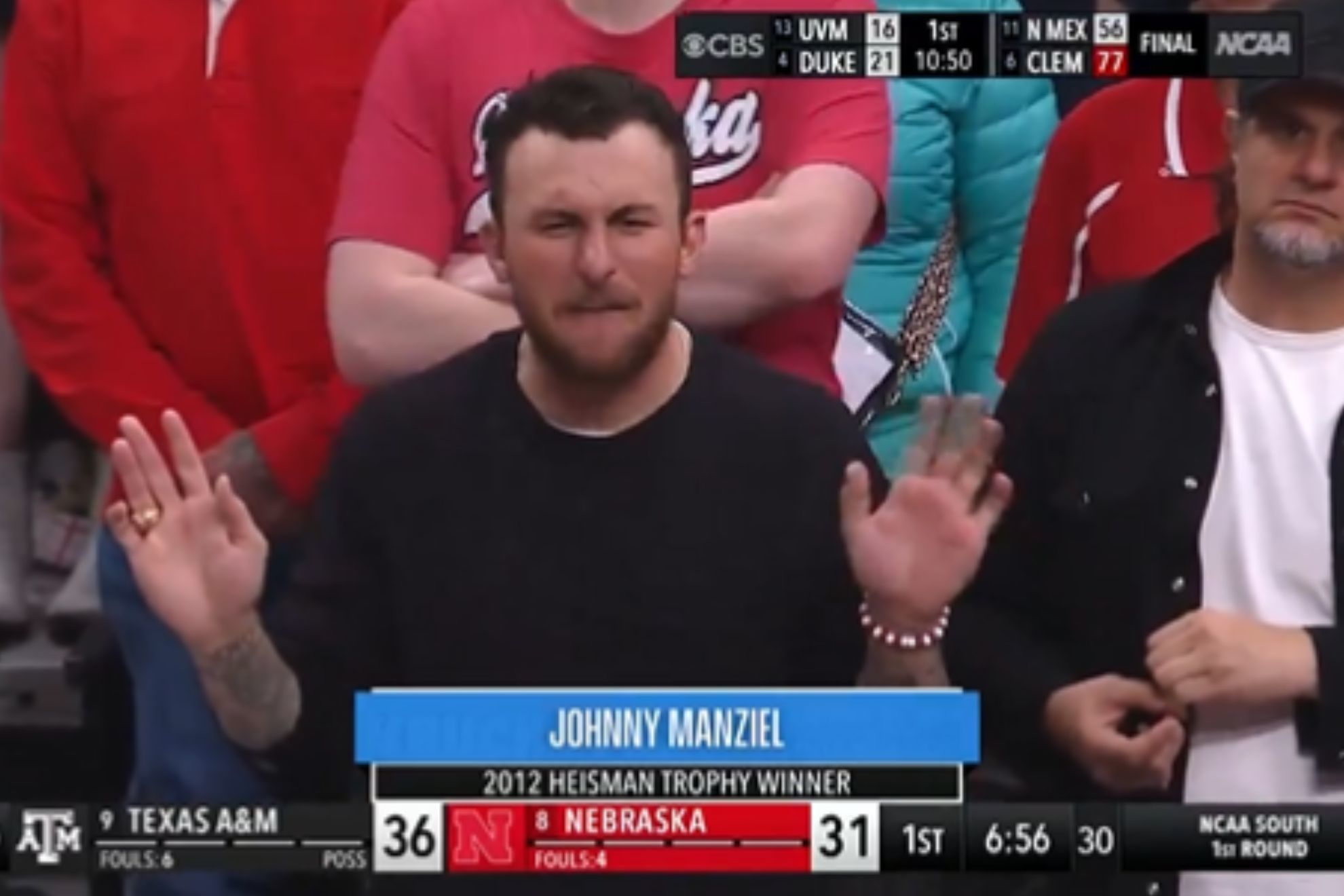 Johnny Manziel sits by Nebraska fans while cheering for Texas A&M in March Madness