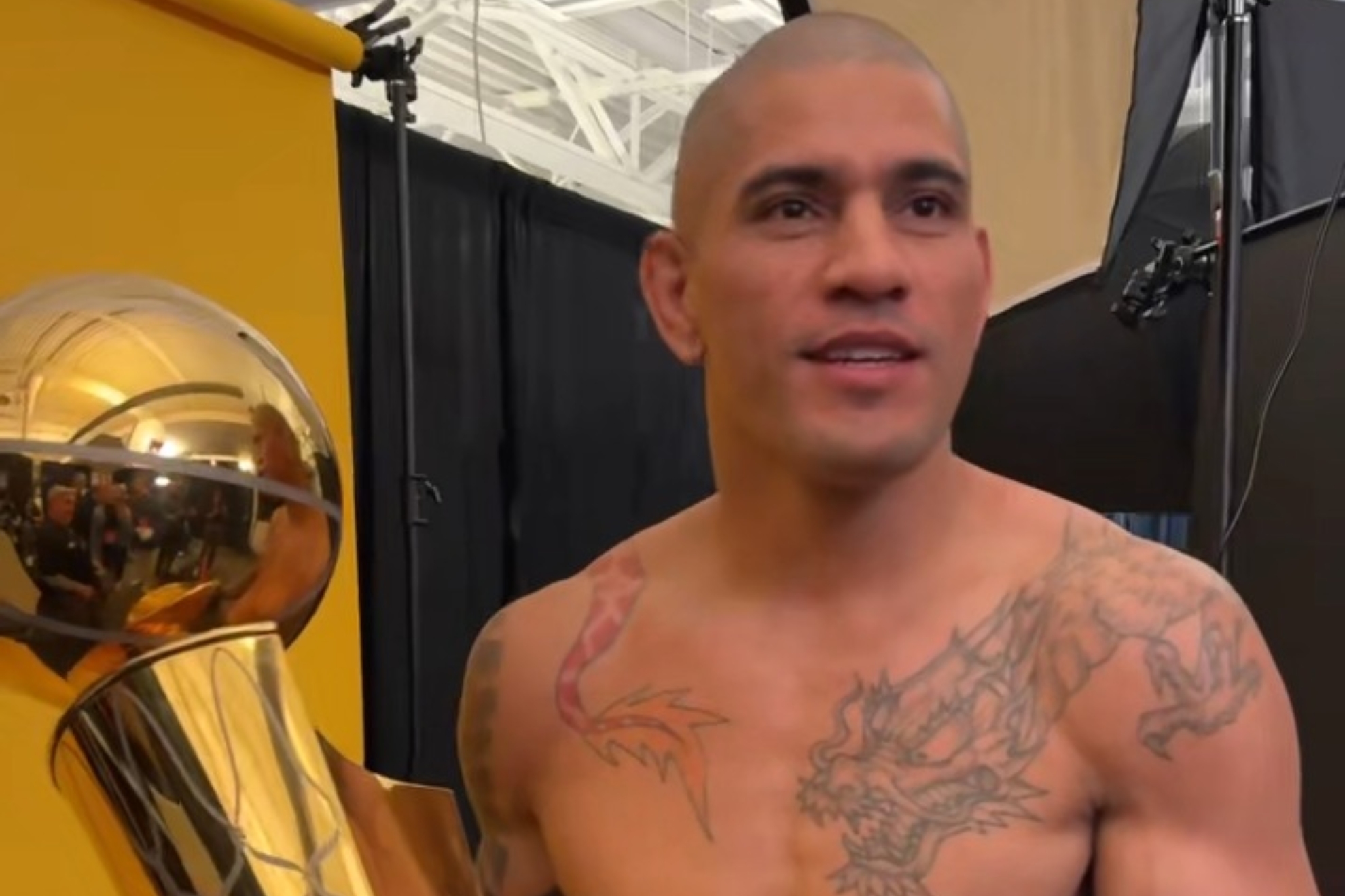 Alex Pereira holding the Larry OBrien NBA trophy