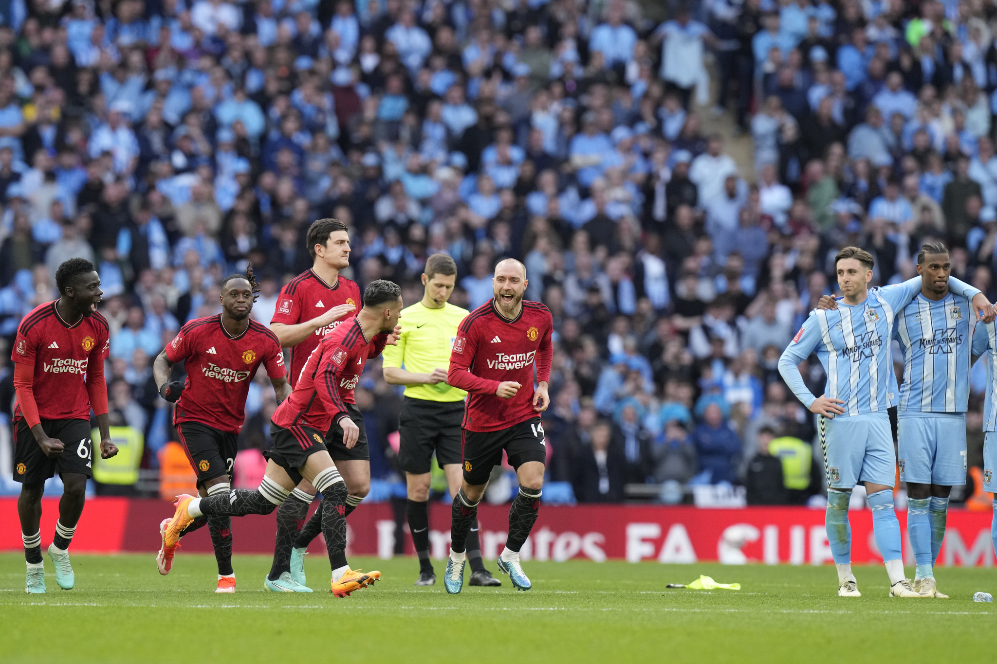 Manchester United players react during a penalty shootout