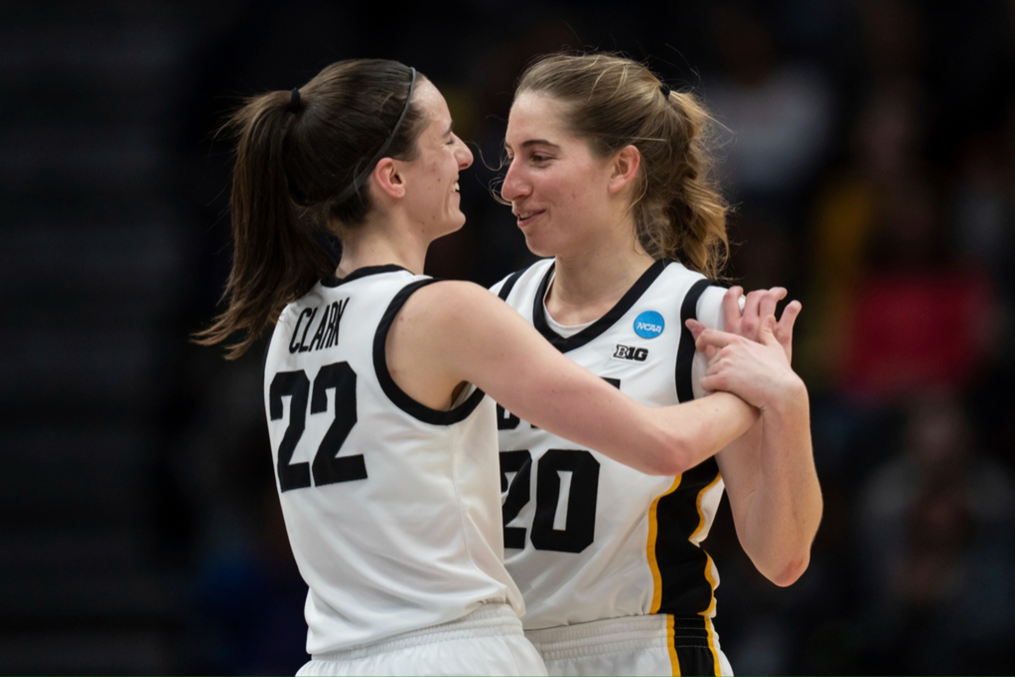 Caitlin Clark (22) and Kate Martin hug during the Elite 8 game against Louisville in 2023.