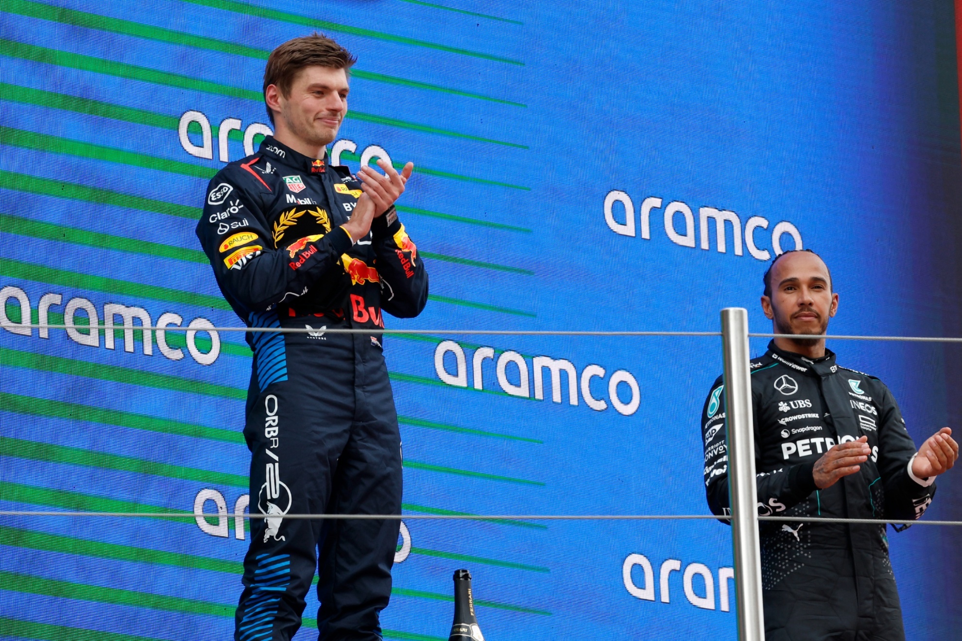 Red Bull driver Max Verstappen of the Netherlands, next to McLaren driver Lando Norris of Britain and Mercedes driver Lewis Hamilton of Britain, celebrates after winning the Formula 1 Spanish Grand Prix race at the Barcelona Catalunya racetrack in Montmelo, near Barcelona, Spain, Sunday, June 23, 2024. (AP Photo/Joan Monfort)