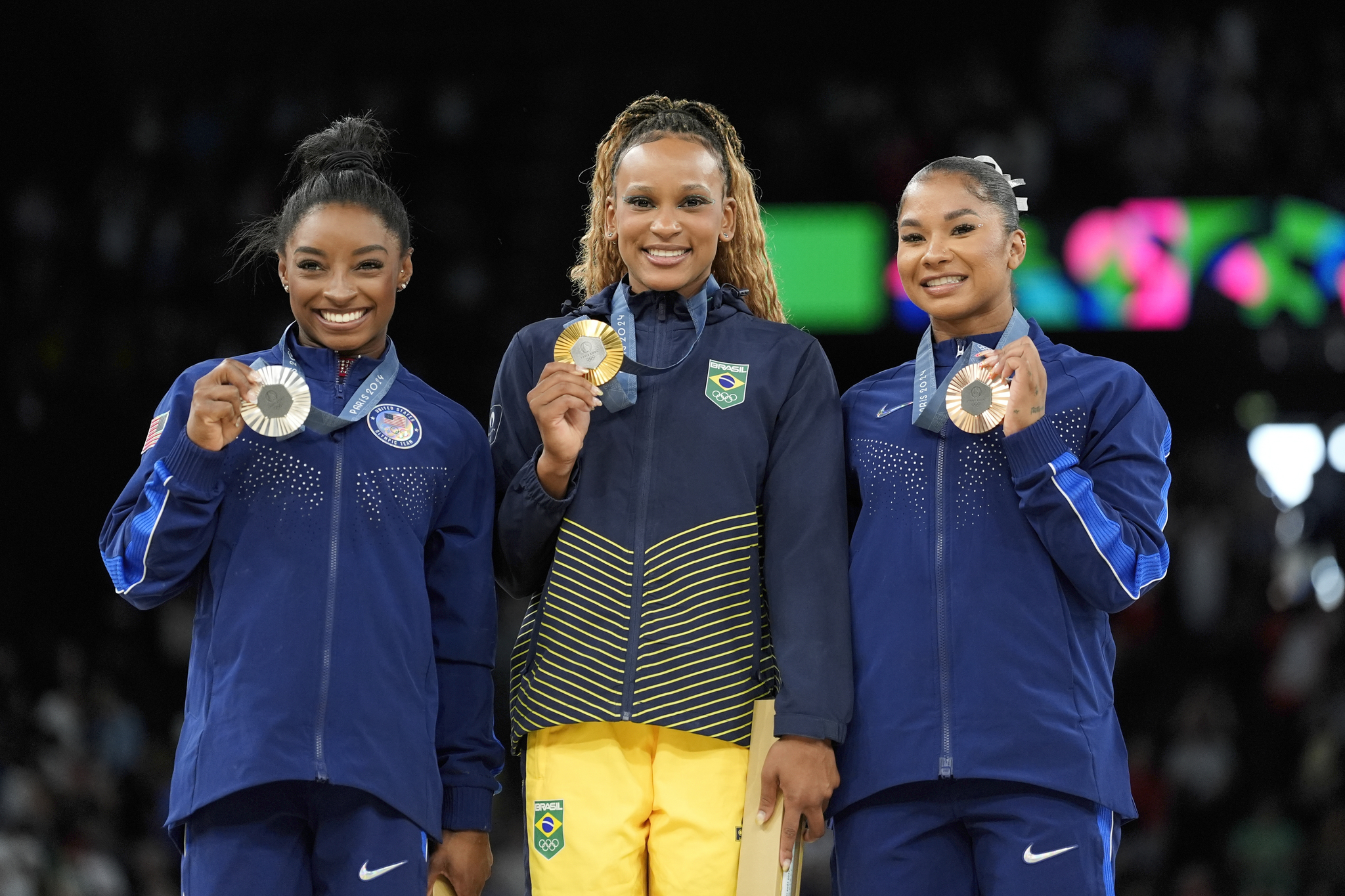 Rebeca Andrade in between Simone Biles and Jordan Chiles