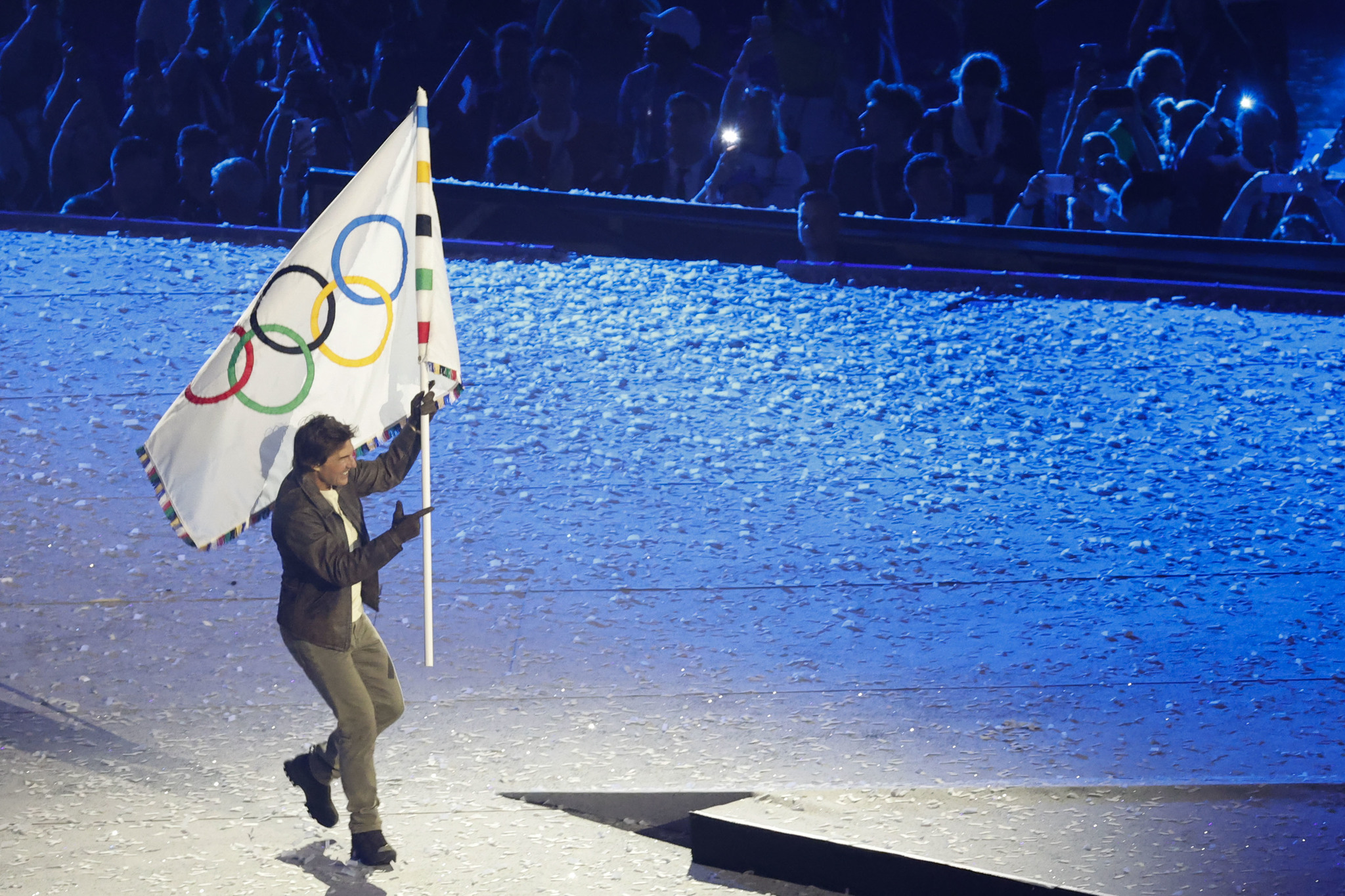 Tom Cruise carries the Olympic flag