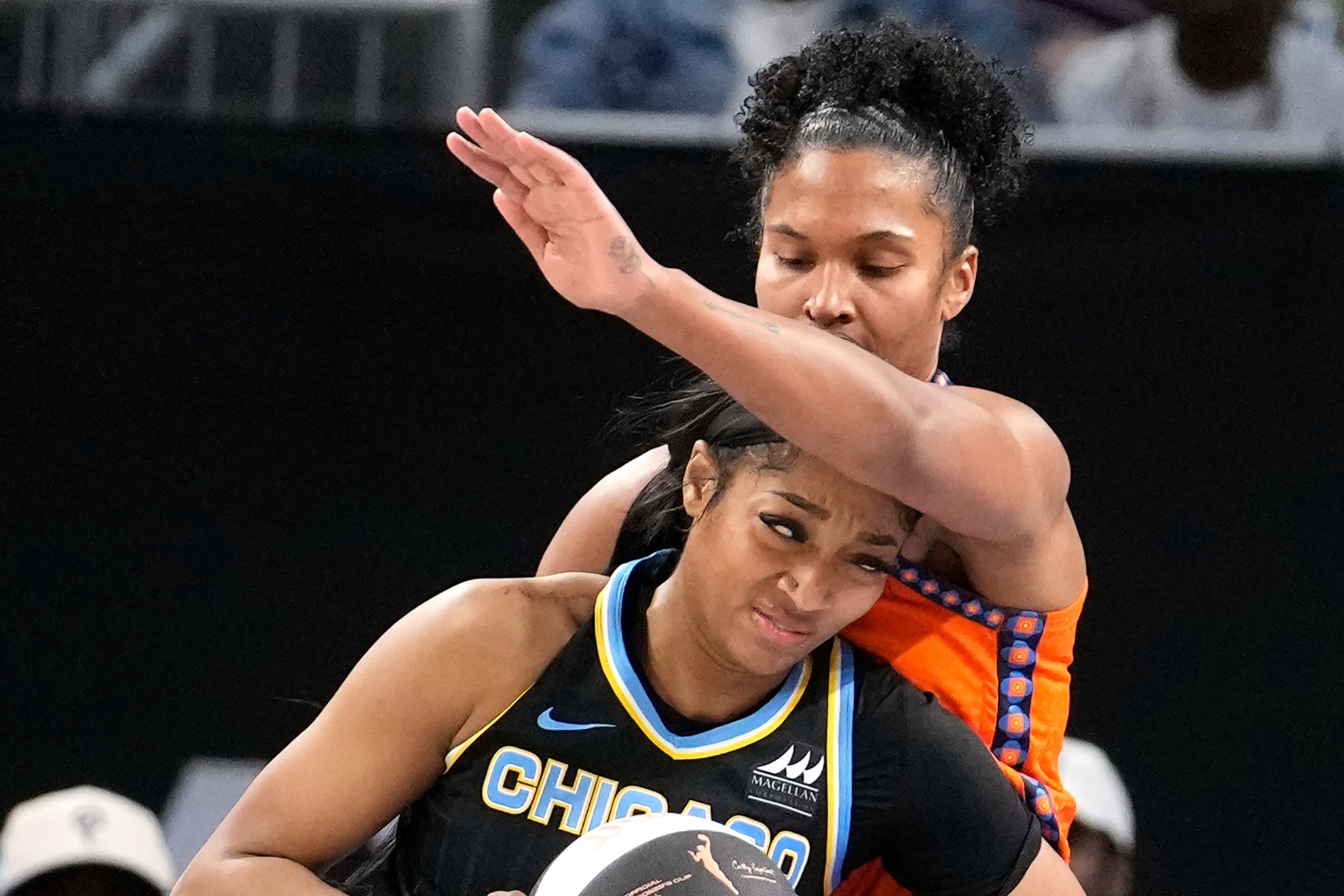 Angel Reese tries to get past Alyssa Thomas in the first matchup between Chicago and Connecticut.