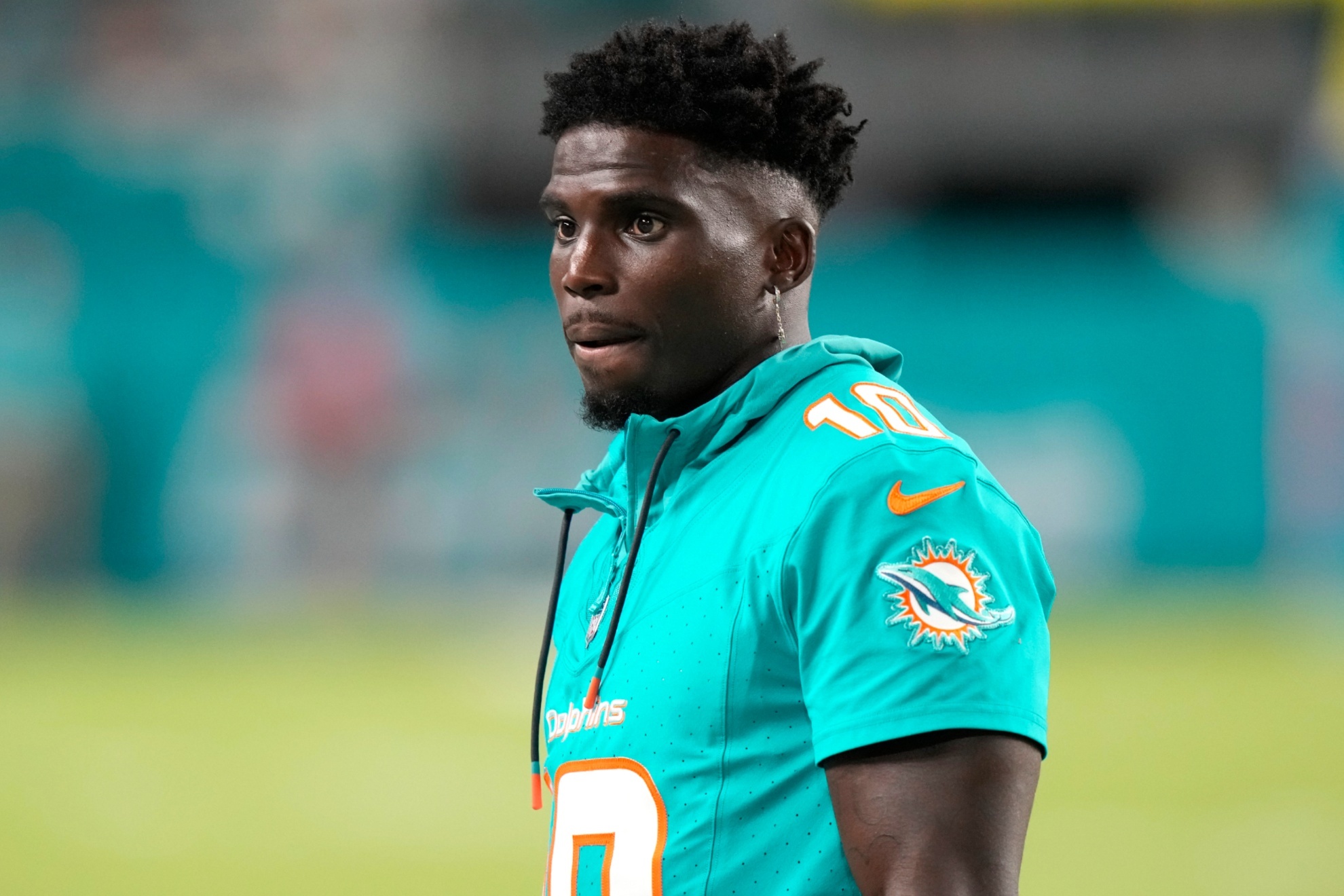 Miami Dolphins wide receiver Tyreek Hill watches from the sideline during the second half of a preseason NFL football game against the Washington Commanders, Saturday, Aug. 17, 2024, in Miami Gardens, Fla. (AP Photo/Wilfredo Lee)