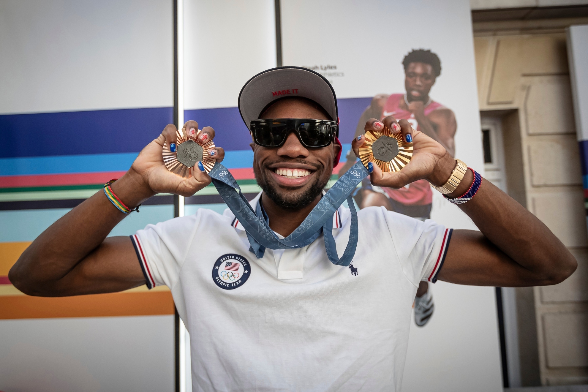 American Olympic champion Noah Lyles poses with his gold and bronze medals before an interview in Paris, France,