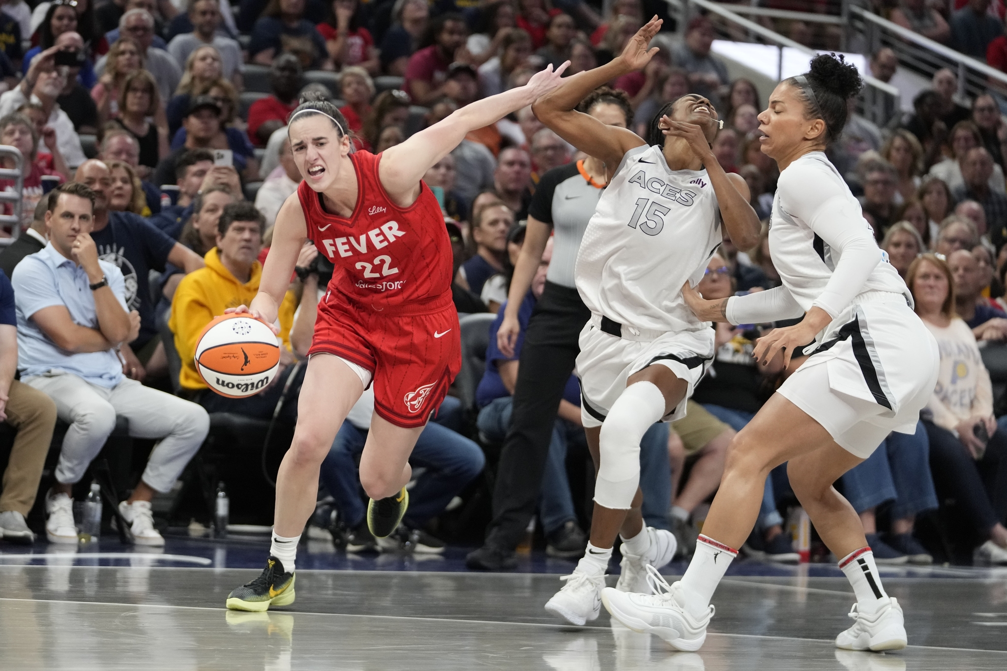 Indiana Fevers Caitlin Clark (22) is called for a foul against Las Vegas Aces Tiffany Hayes (15) during the first half of a WNBA basketball game