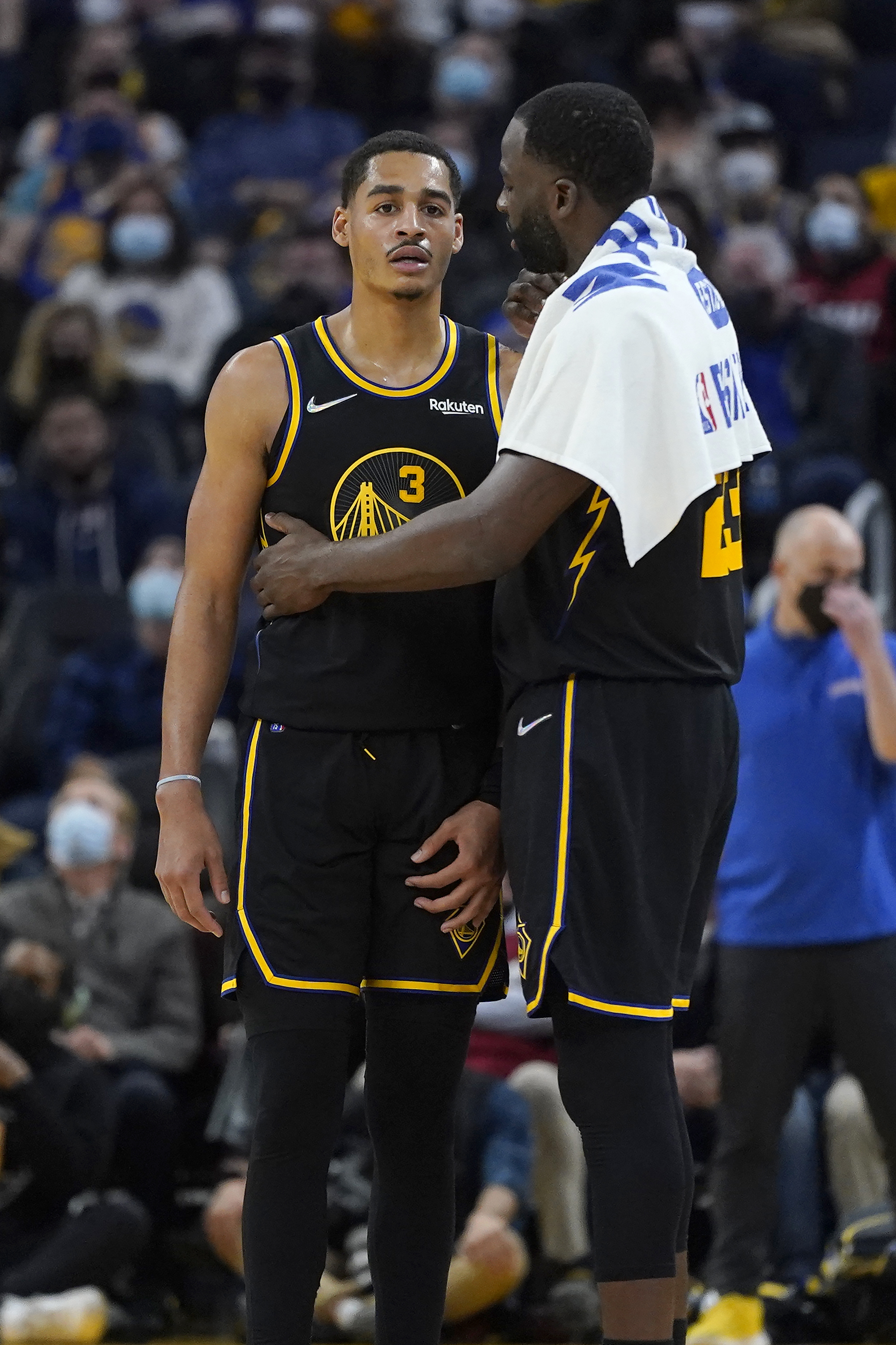 Golden State Warriors guard Jordan Poole (3) talks with forward Draymond Green against the Miami Heat during an NBA basketball