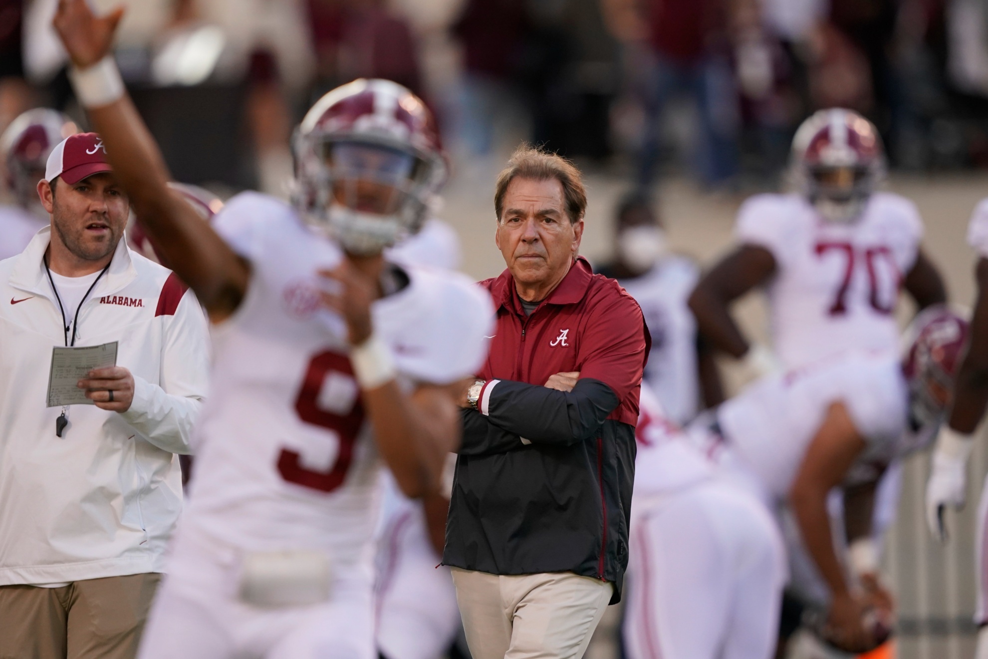 Alabama head coach Nick Saban watches quarterback Bryce Young (9) pass during warmups prior to their NCAA college football game against Mississippi State in Starkville, Miss., Saturday, Oct. 16, 2021. Alabama won 49-9. (AP Photo/Rogelio V. Solis)