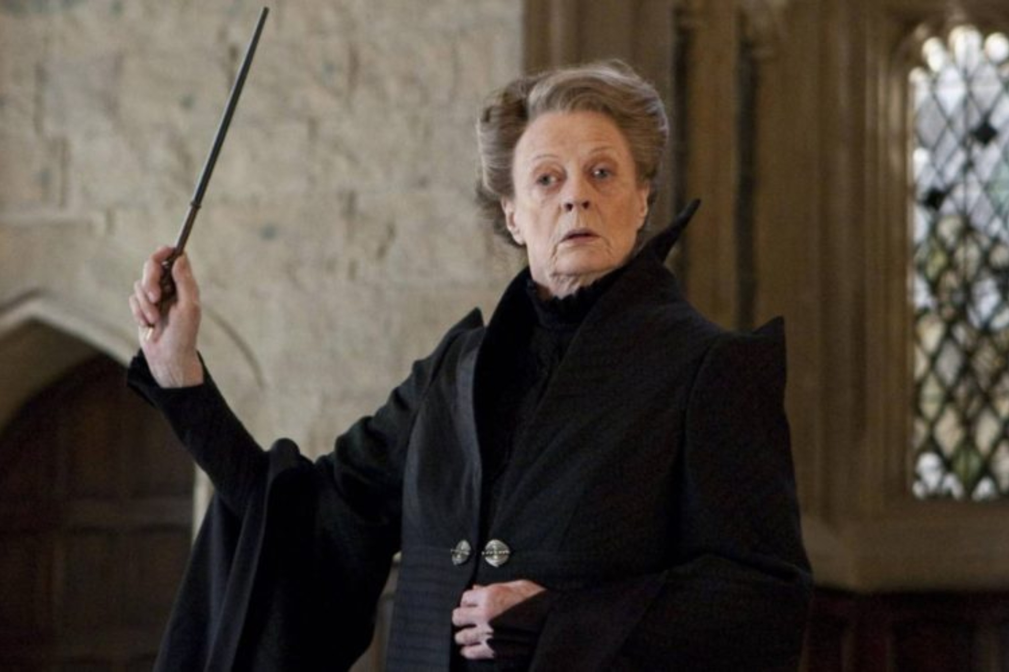 Harry Potter fans gather at Hogwarts castle with wands in the air in honor of Maggie Smith