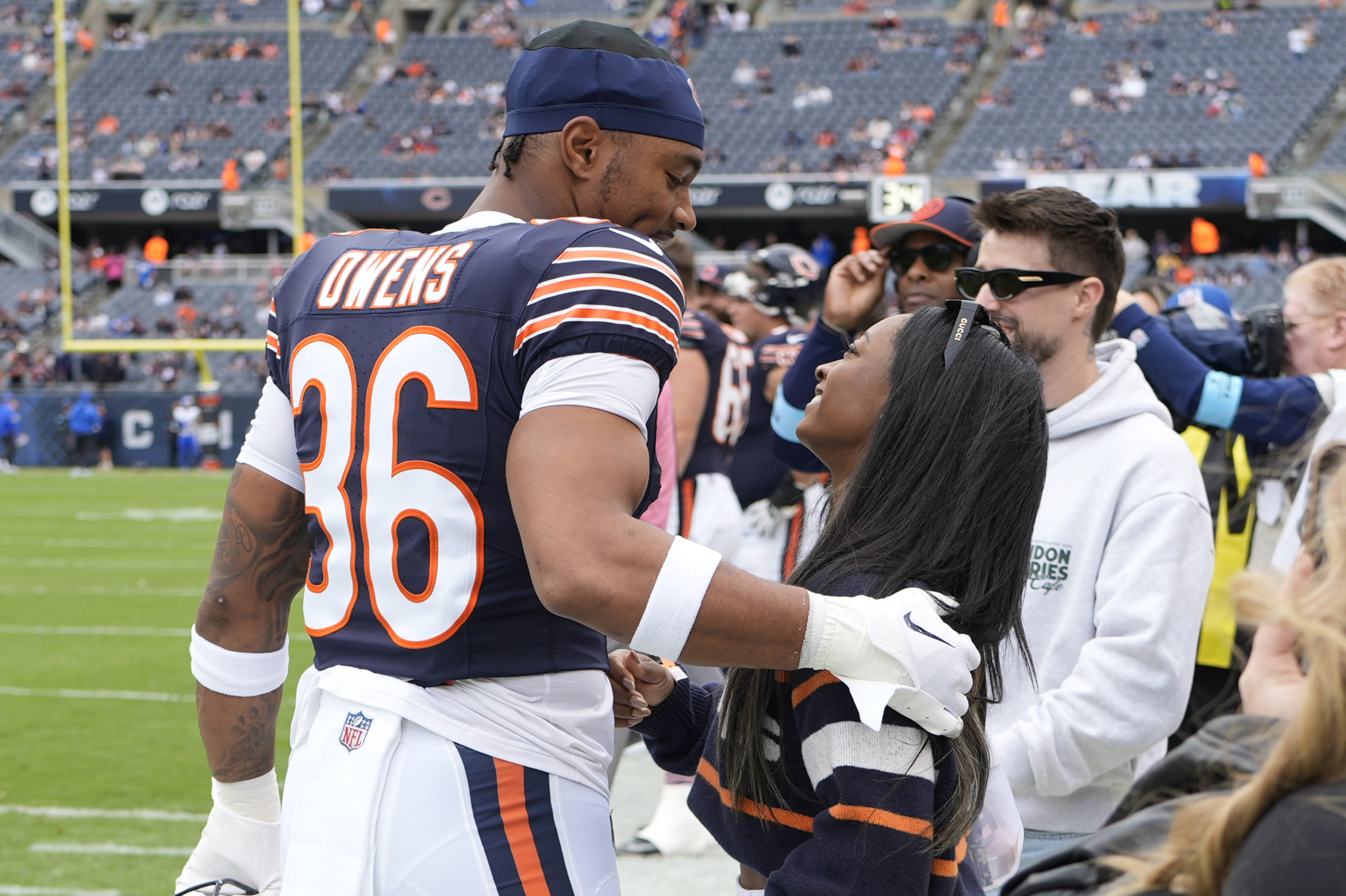 Chicago Bears safety Jonathan Owens talks with his wife Simone Biles before an NFL football game