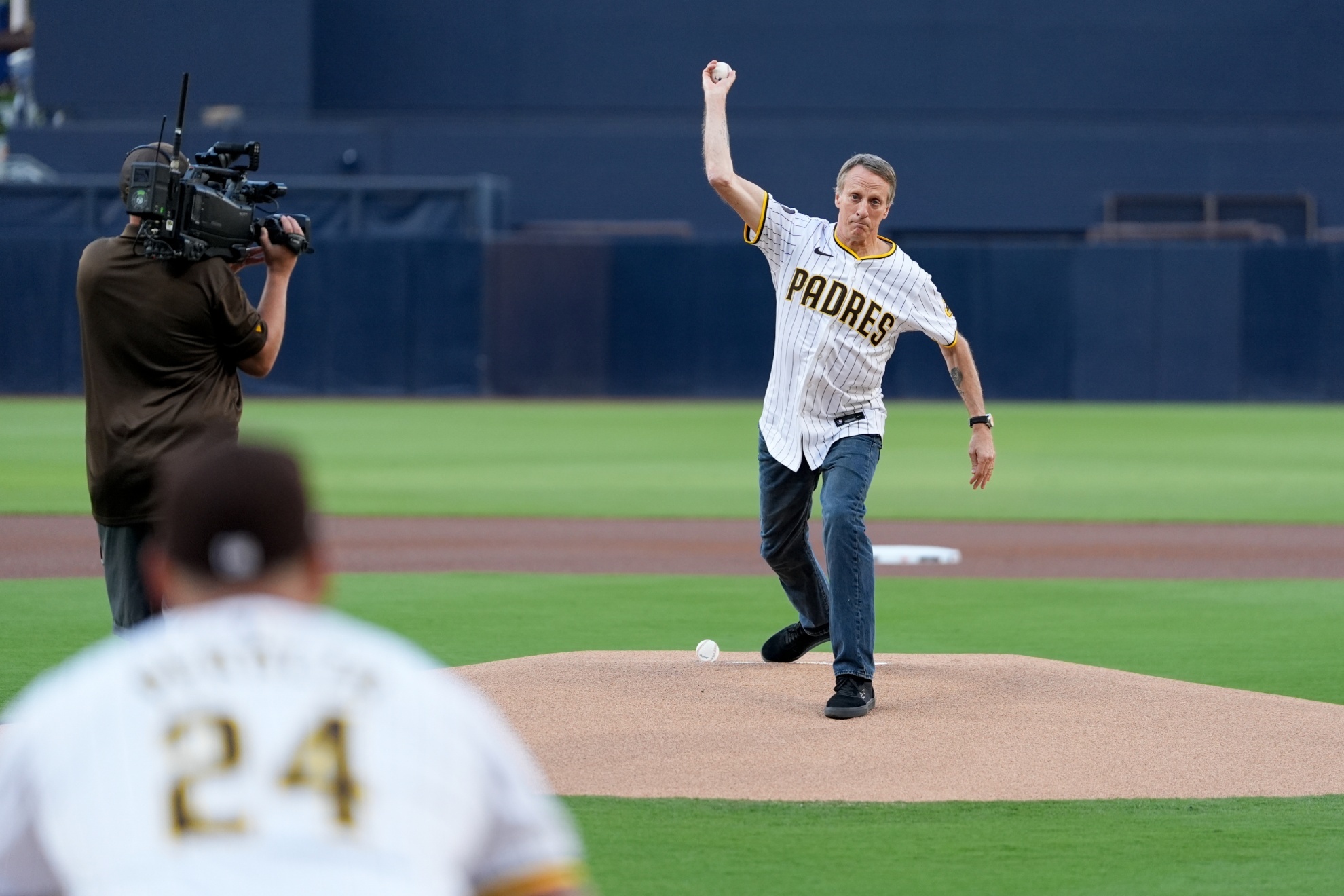 Professional skateboarder Tony Hawk throws the ceremonial first pitch before Game 2 of an NL Wild Card Series baseball game between the Atlanta Braves and the San Diego Padres, Wednesday, Oct. 2, 2024, in San Diego. (AP Photo/Gregory Bull)