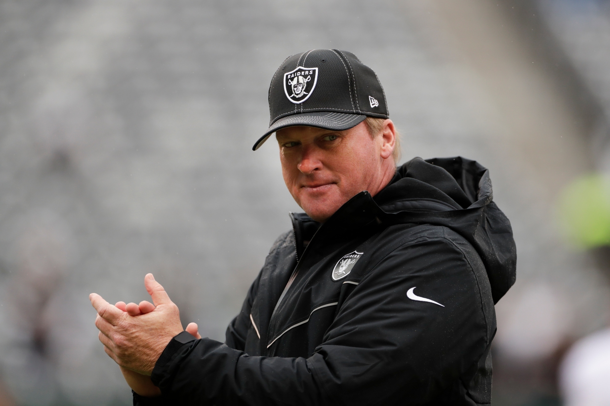 Oakland Raiders head coach Jon Gruden watches his team warm up before an NFL football game against the New York Jets Sunday, Nov. 24, 2019, in East Rutherford, N.J.