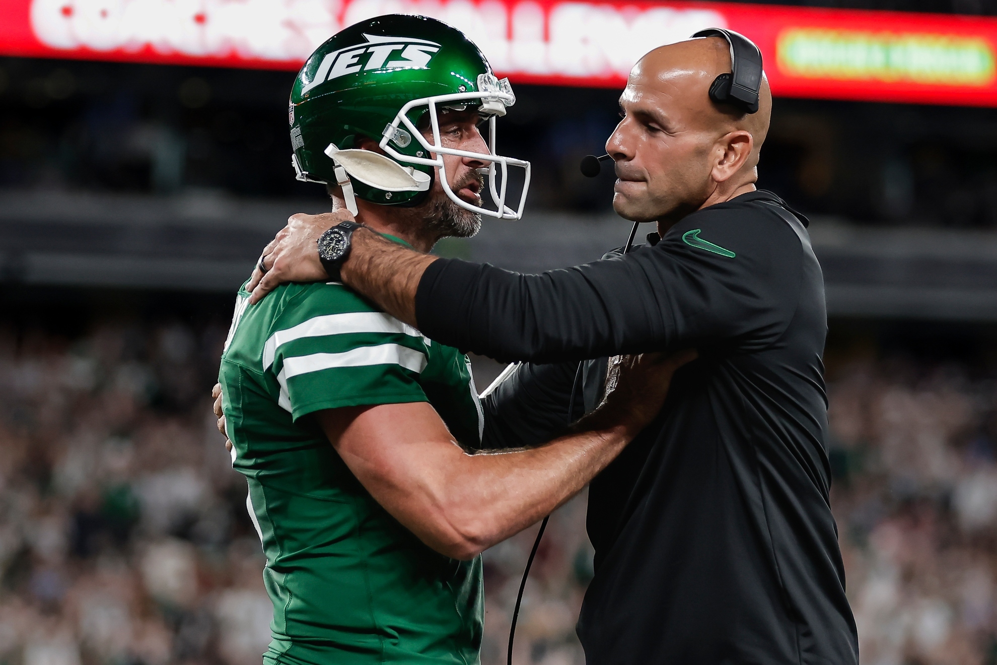 New York Jets quarterback Aaron Rodgers (8) talks with New York Jets head coach Robert Saleh during the first quarter of an NFL football game against the New England Patriots, Thursday, Sept. 19, 2024, in East Rutherford, N.J. (AP Photo/Adam Hunger)