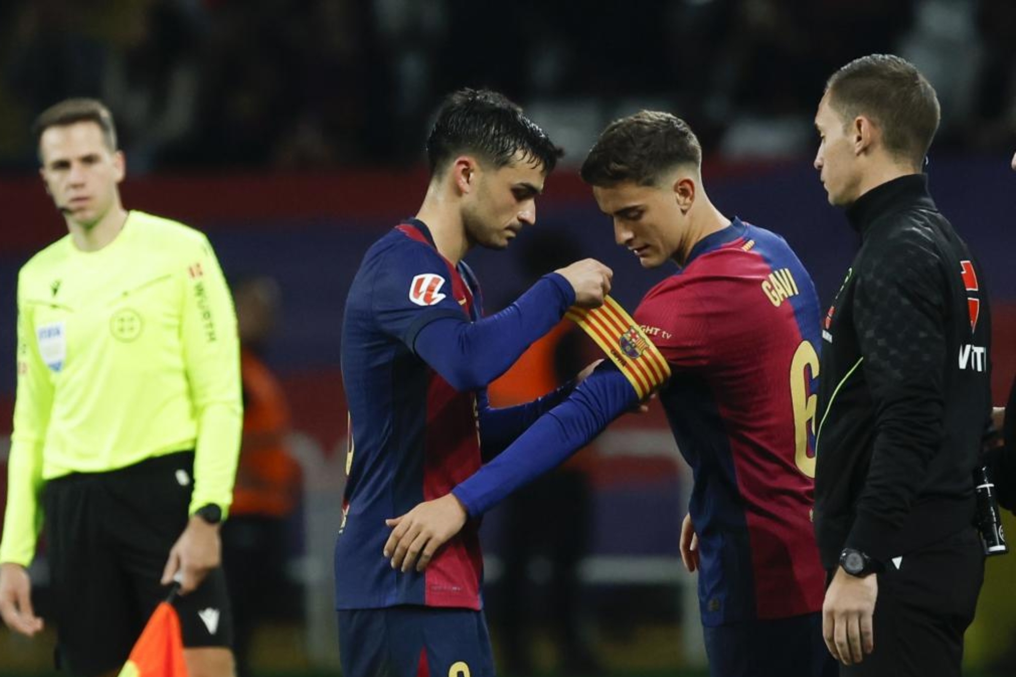 Pedri giving Gavi the capitains band