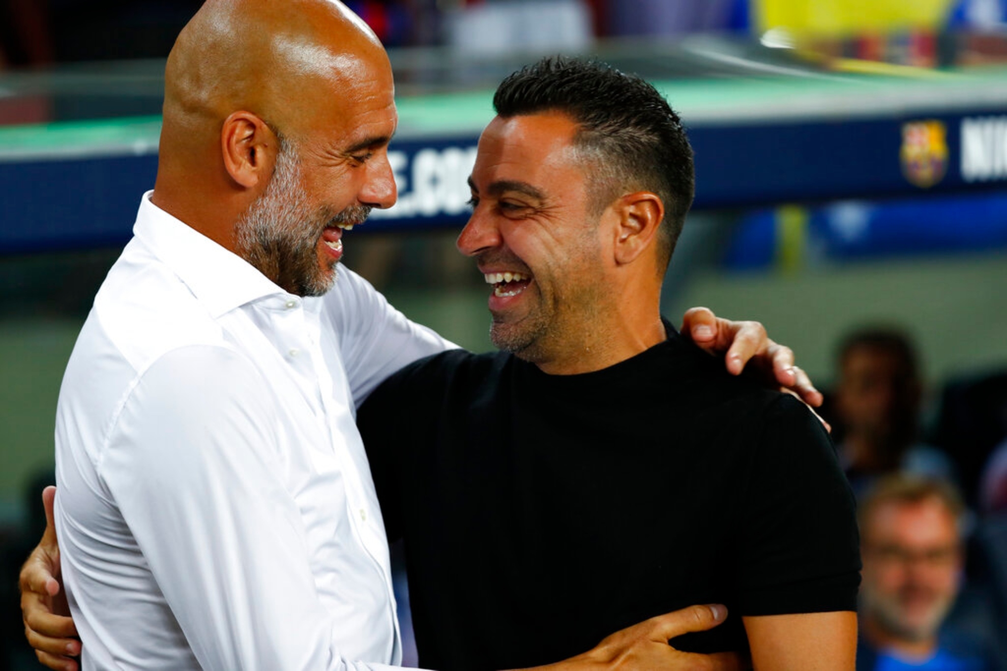 Guardiola and Xavi greet each other during a game