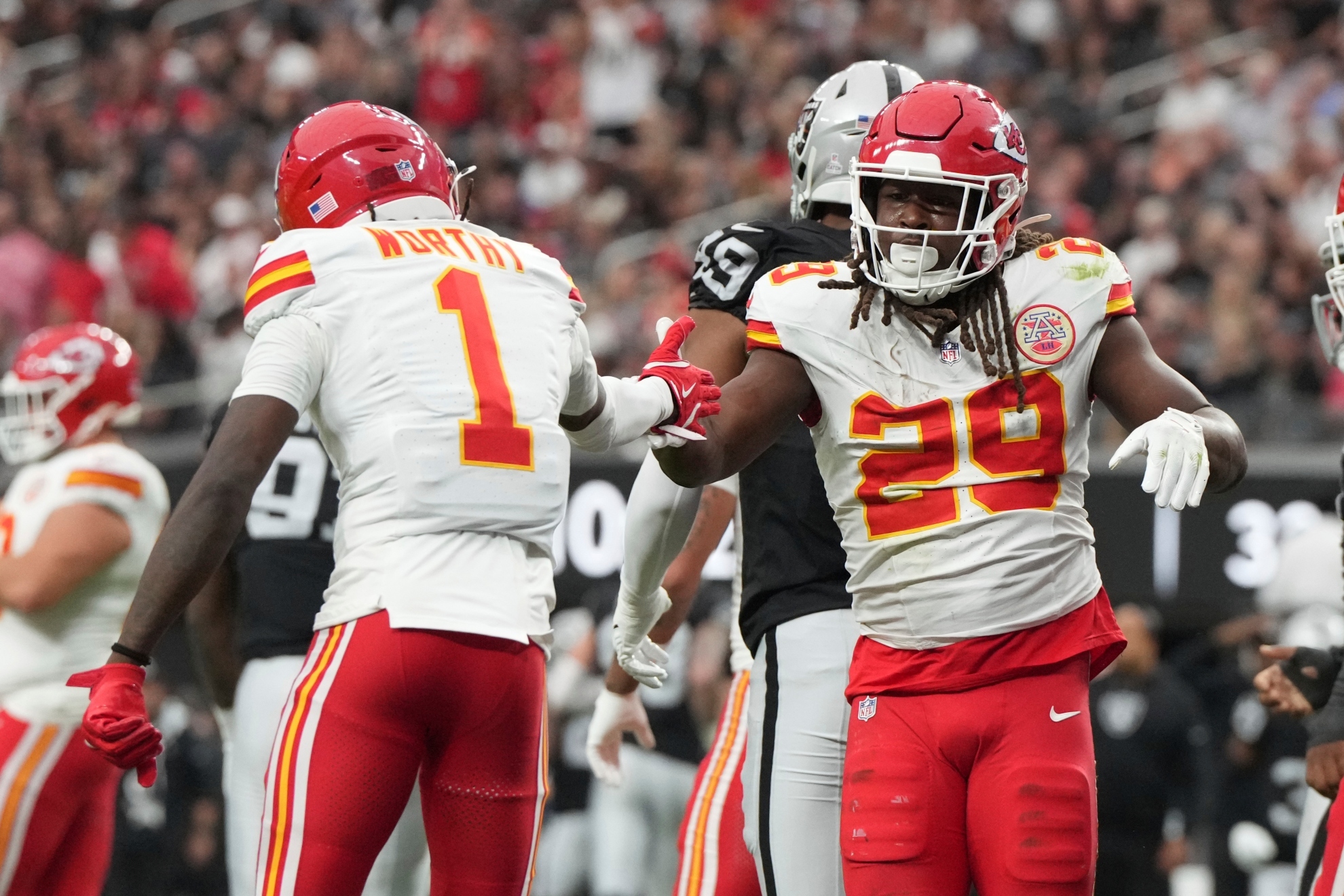 Kansas City Chiefs running back Kareem Hunt (29) is congratulated by wide receiver Xavier Worthy (1) after scoring during the first half of an NFL football game against the Las Vegas Raiders Sunday, Oct. 27, 2024, in Las Vegas. (AP Photo/Rick Scuteri)