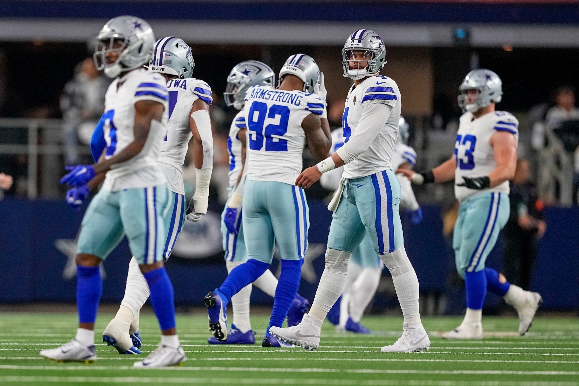 Dallas Cowboys quarterback Dak Prescott, second from right, heads to the bench after his pass was intercepted and returned for a touchdown by Green Bay Packers safety Darnell Savage during the first half of an NFL football game, Sunday, Jan. 14, 2024, in Arlington, Texas.