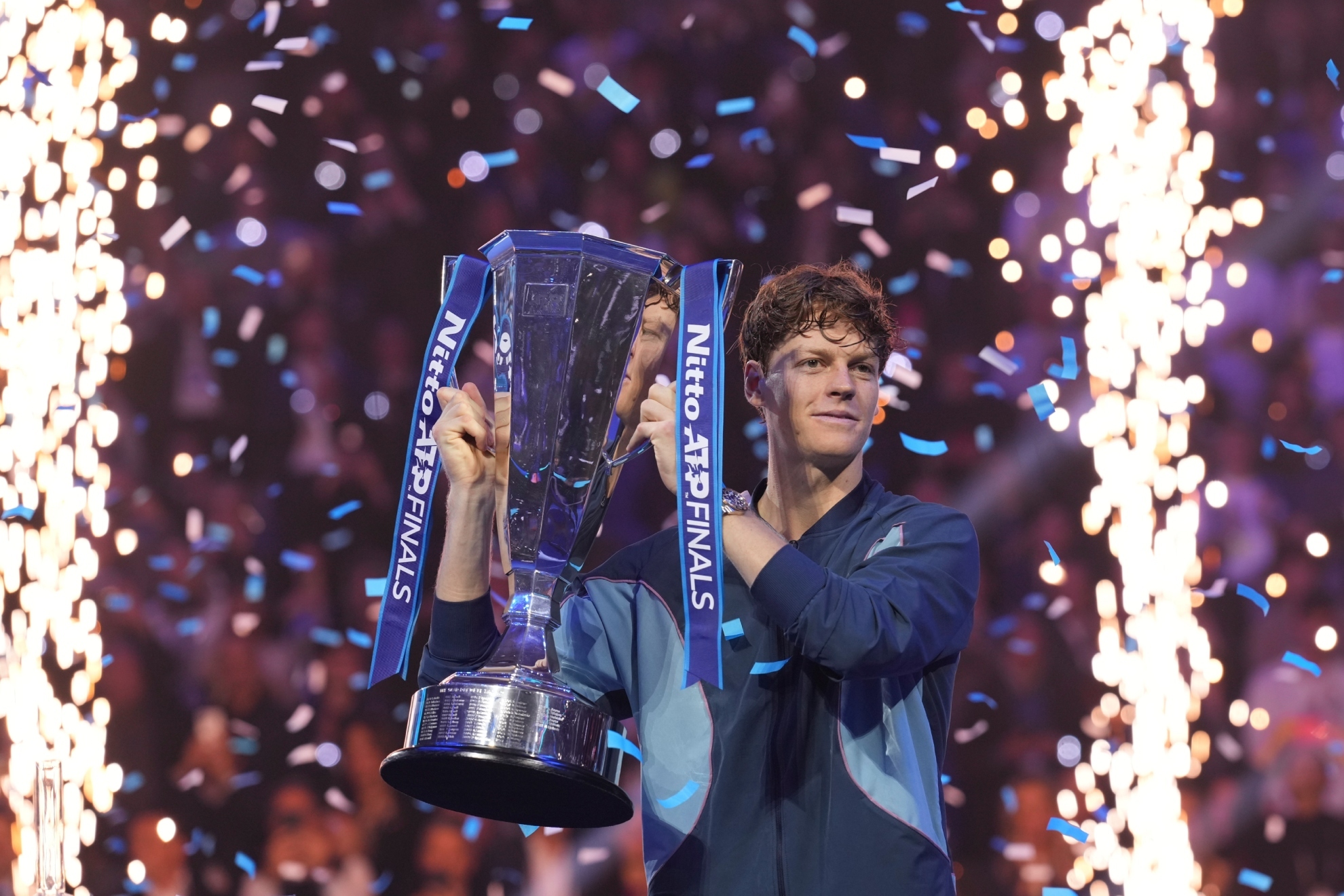 Italys Jannik Sinner holds the trophy after winning the final match of the ATP World Tour Finals against Taylor Fritz of the United States at the Inalpi Arena, in Turin, Italy, Sunday, Nov. 17, 2024.