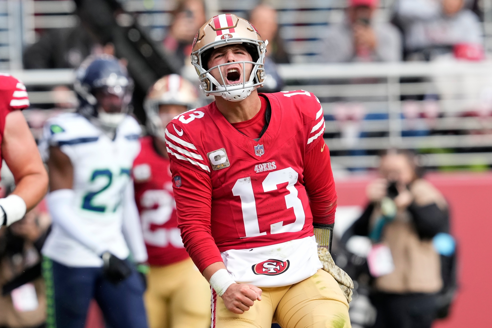 San Francisco 49ers quarterback Brock Purdy (13) celebrates after scoring against the Seattle Seahawks during the first half of an NFL football game in Santa Clara, Calif., Sunday, Nov. 17, 2024.