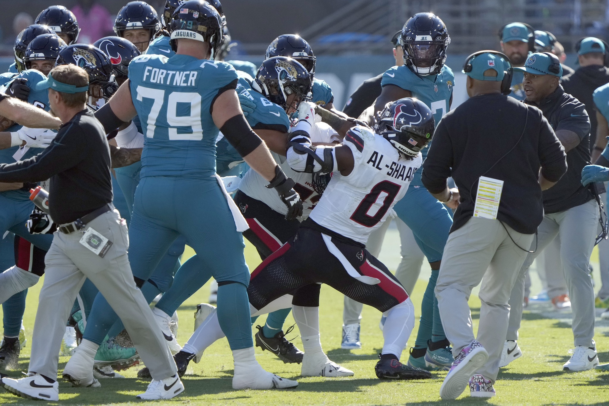 Players fight after Houston Texans linebacker Azeez Al-Shaair (0) hit Jacksonville Jaguars quarterback Trevor Lawrence with a late hit