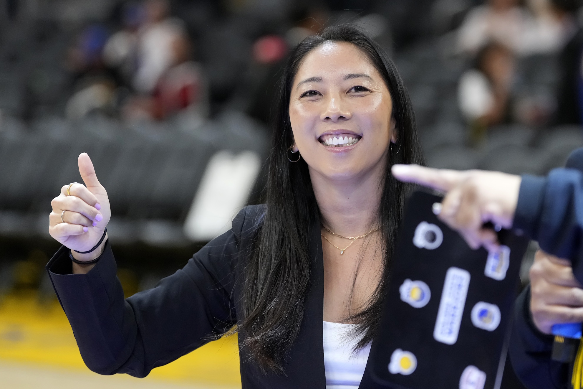Golden State Valkyries WNBA head coach Natalie Nakase waves before an NBA.