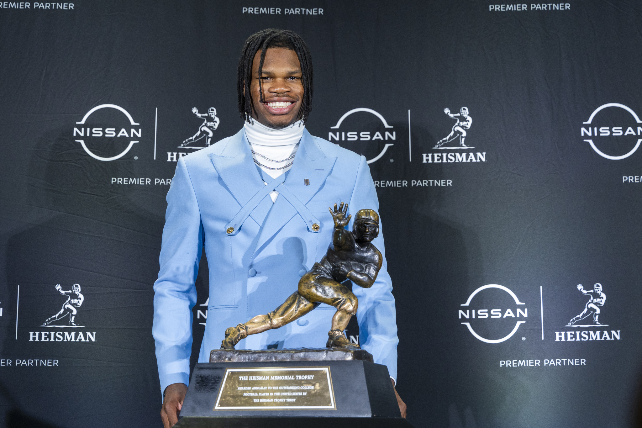 Heisman Trophy finalist  lt;HIT gt;Travis lt;/HIT gt;  lt;HIT gt;Hunter lt;/HIT gt;, of Colorado, stands with the trophy during a college football press conference, Saturday, Dec. 14, 2024, in New York. (AP Photo/Corey Sipkin)
