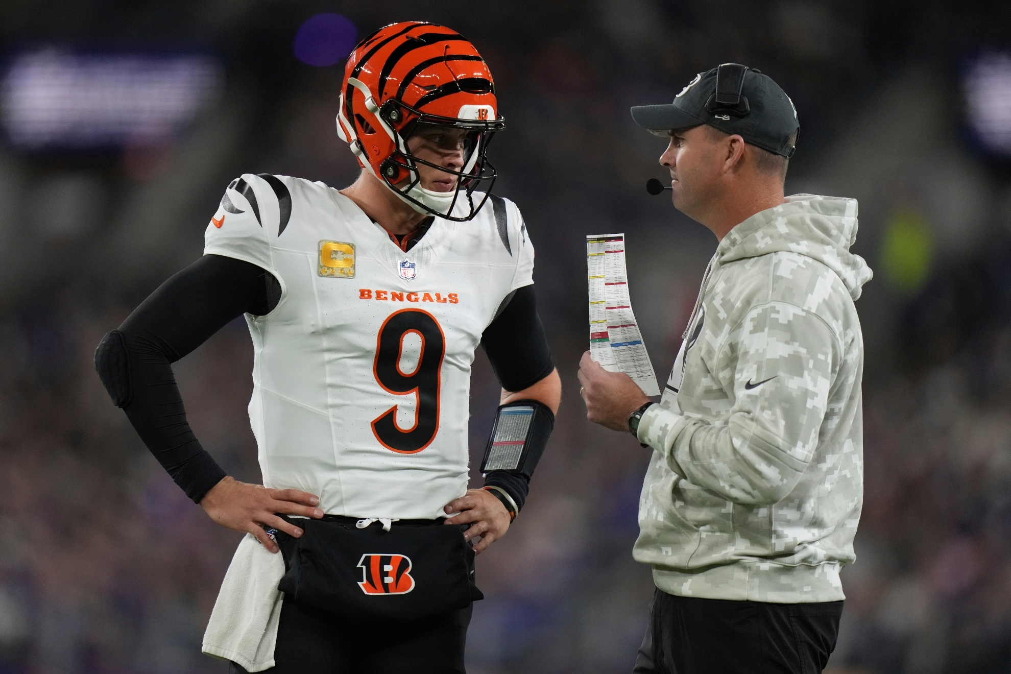 Cincinnati Bengals quarterback Joe Burrow, left, talks with head coach Zac Taylor during the first half of an NFL football game against the Baltimore Ravens, Thursday, Nov. 7, 2024, in Baltimore.