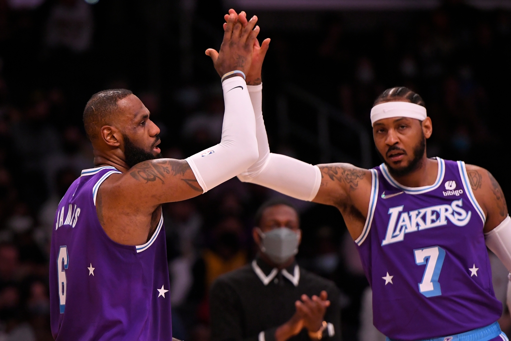 Los Angeles Lakers forward LeBron James (6) and forward Carmelo Anthony (7) celebrate while playing the Portland Trail Blazers in an NBA basketball game, Friday Dec. 31, 2021, in Los Angeles.