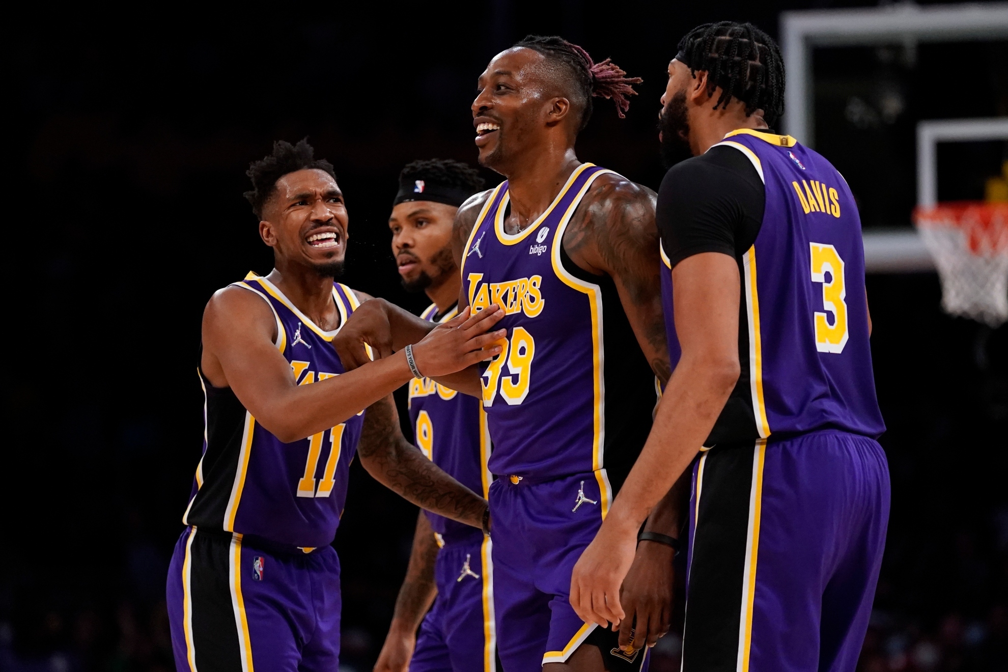 Los Angeles Lakers center Dwight Howard (39) celebrates with guard Malik Monk (11) and forward Anthony Davis (3) after scoring during the first half of an NBA basketball game against the Miami Heat in Los Angeles, Wednesday, Nov. 10, 2021.