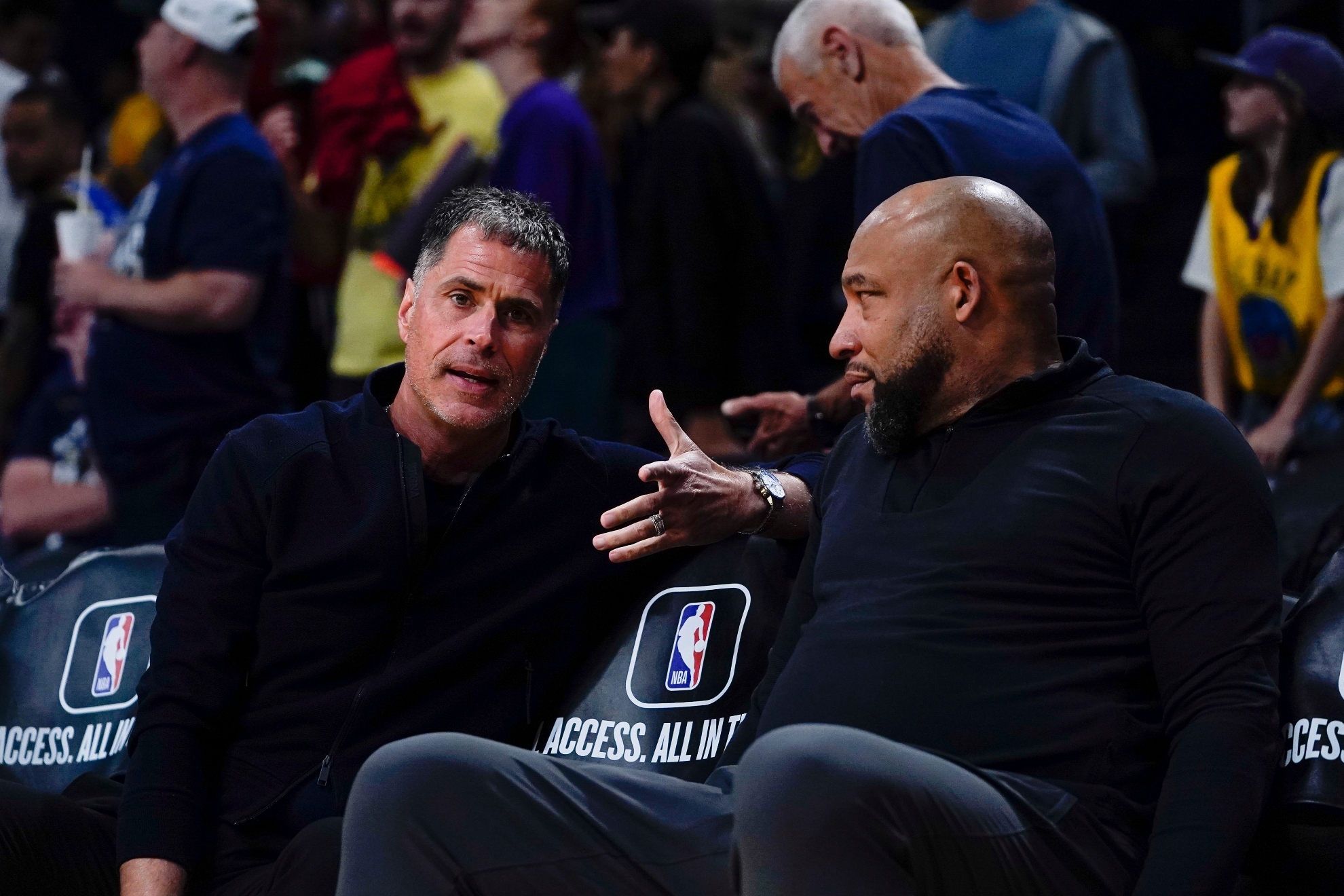 Los Angeles Lakers general manager Rob Pelinka, left, and head coach Darvin Ham speak before an NBA basketball game against the Golden State Warriors, Tuesday, April 9, 2024, in Los Angeles