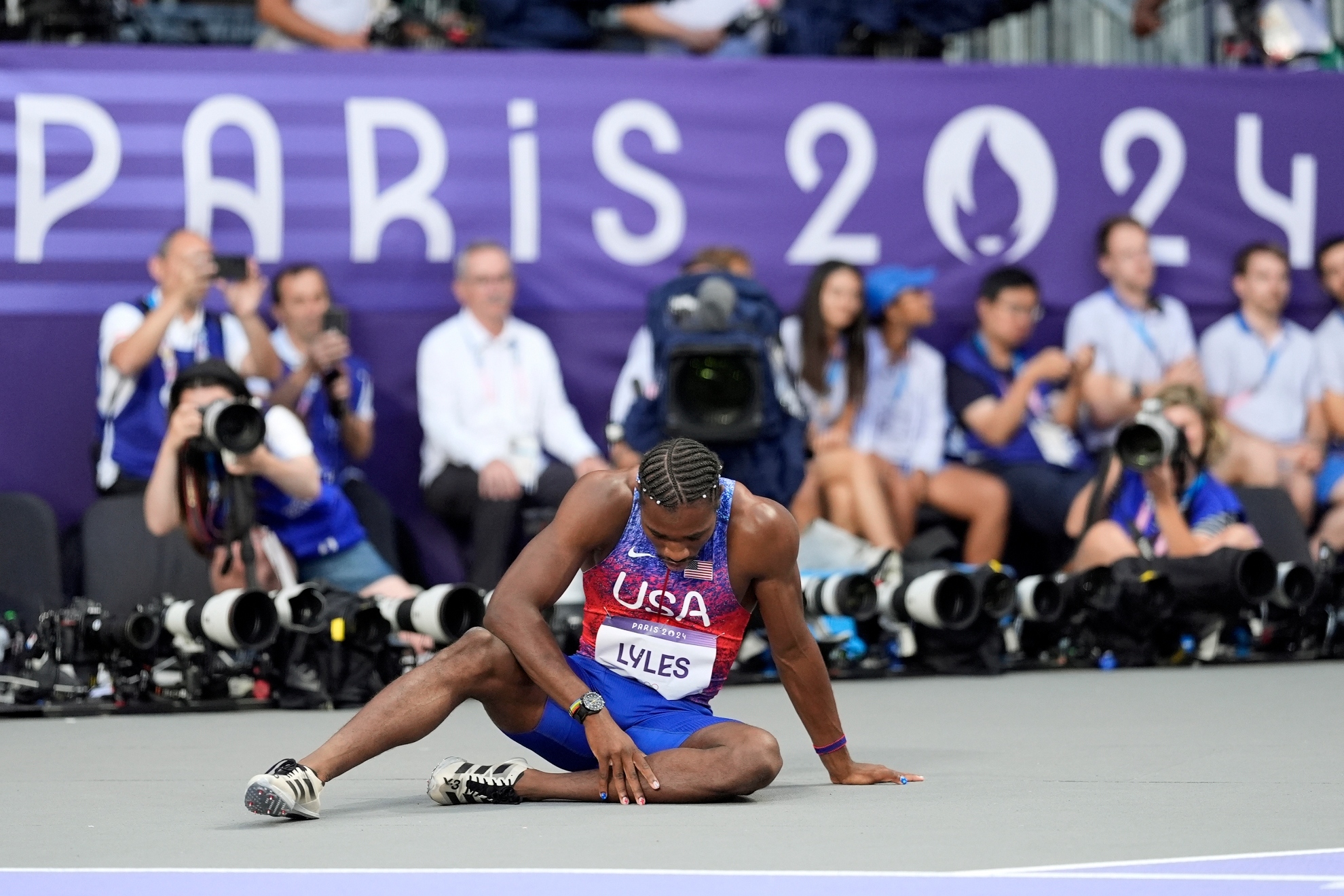 Noah Lyles, of the United States, pauses on the track after the mens 200-meter final at the 2024 Summer Olympics, Thursday, Aug. 8, 2024, in Saint-Denis, France.