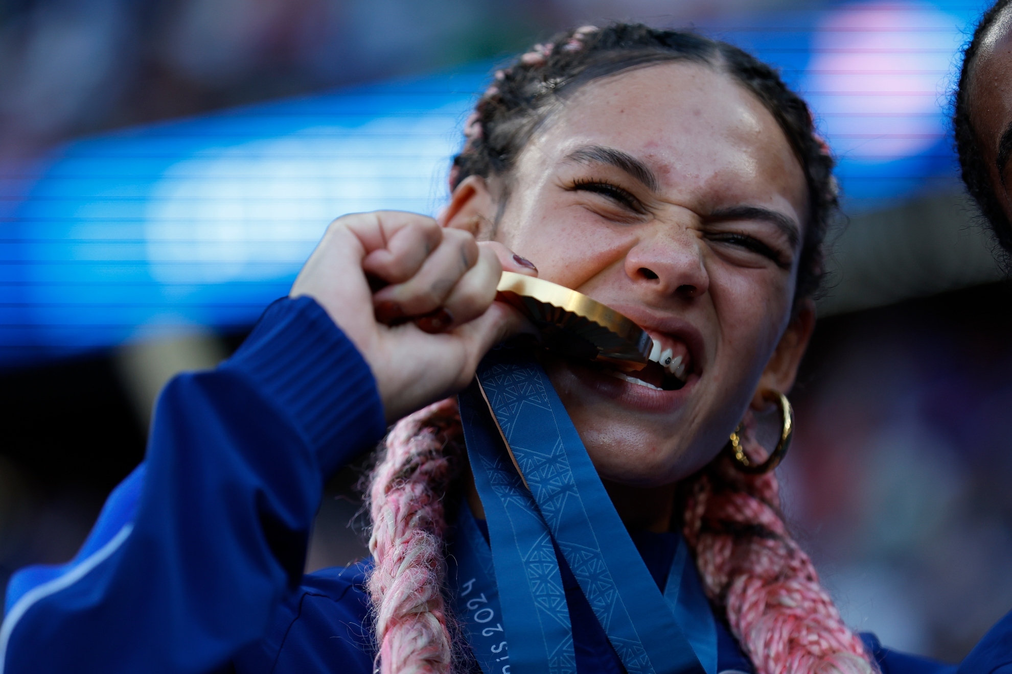 Trinity Rodman of the United States bites her gold medal at the 2024 Paris Olympics.