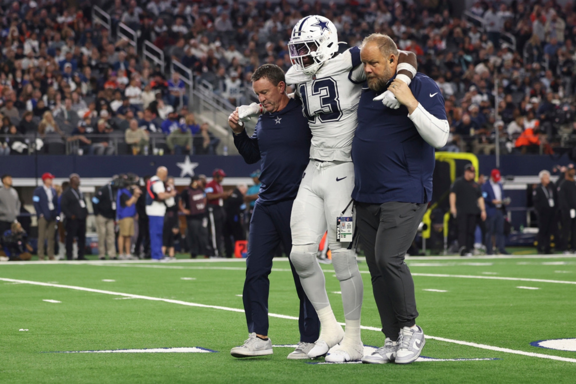 Dallas Cowboys linebacker DeMarvion Overshown is helped off the field after being injured.