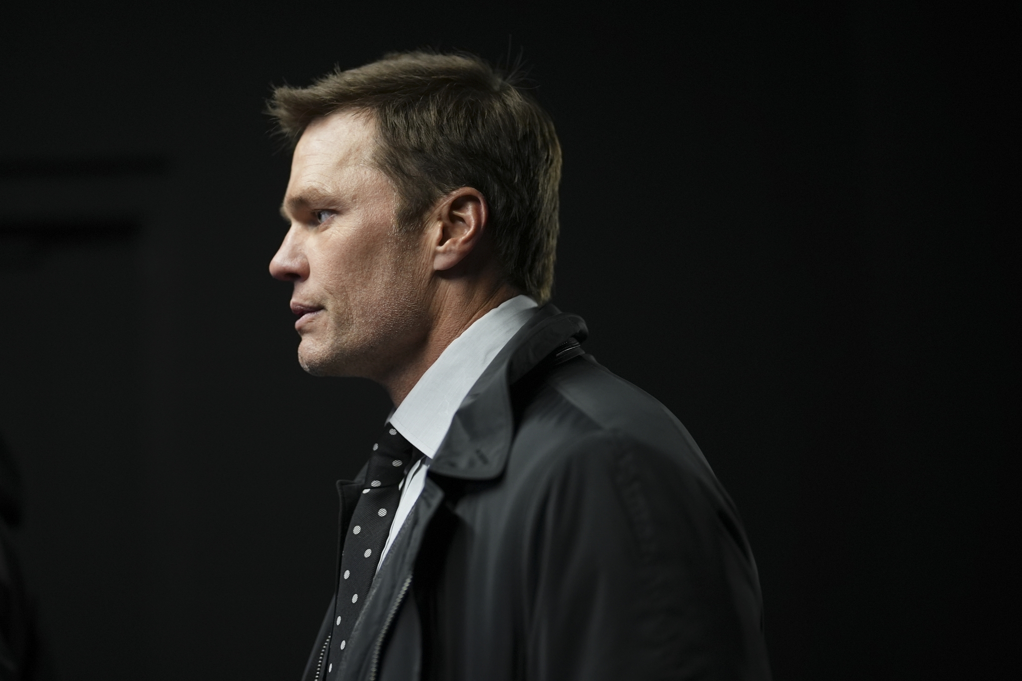 Tom Brady walks in a tunnel before an NFL football game