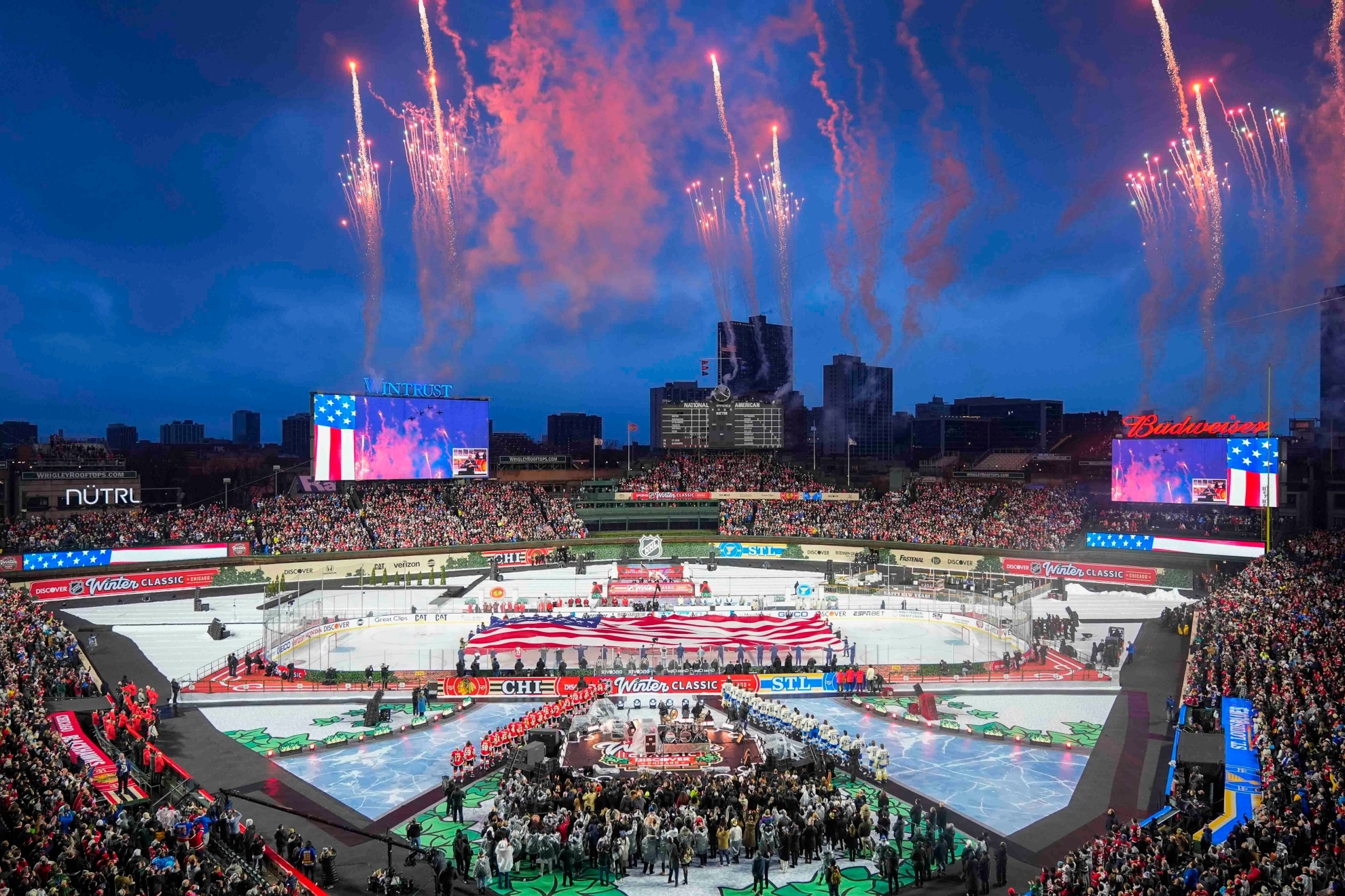 Fireworks explode during the Star-Spangled Banner before the NHL Winter Classic at Wrigley Field.