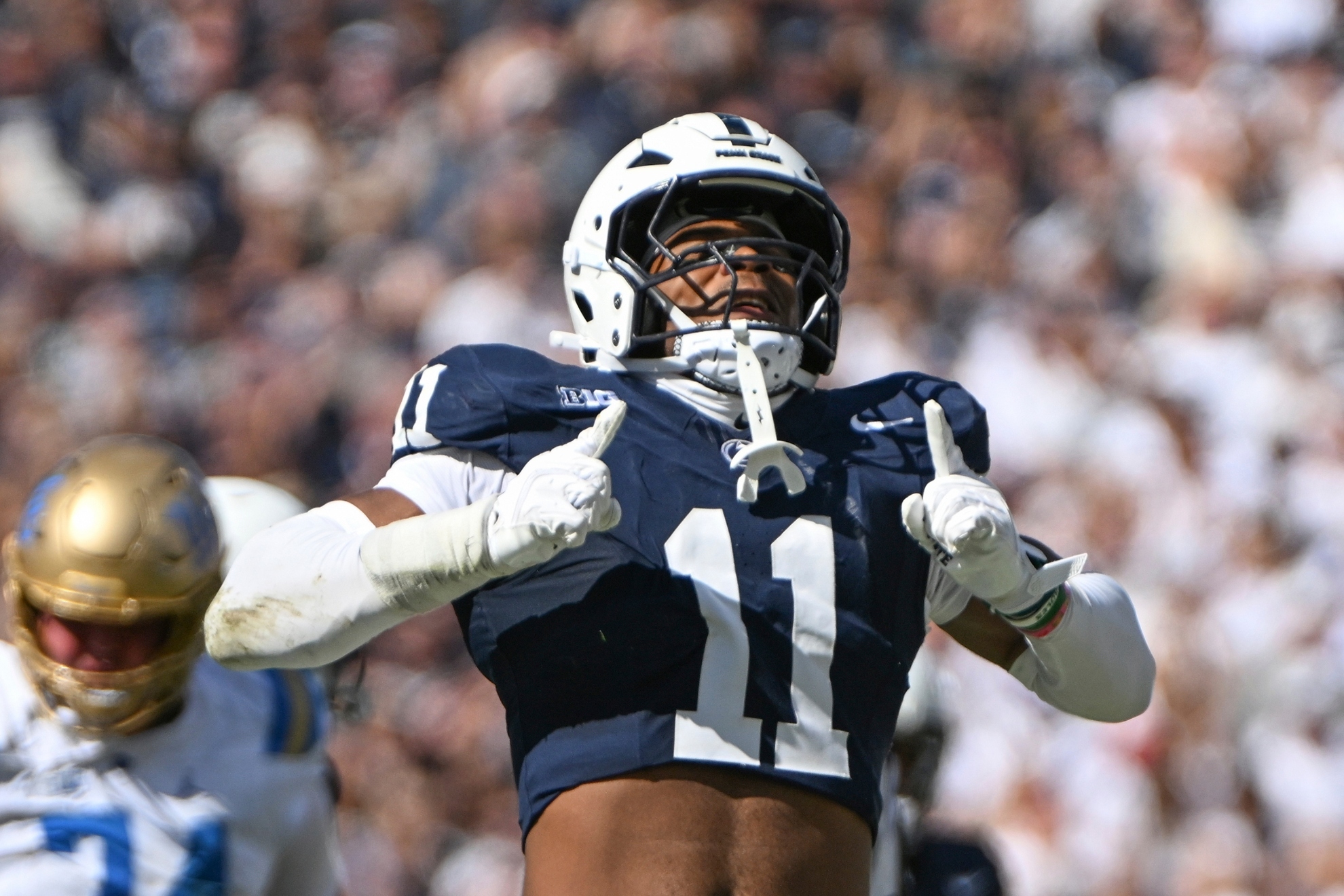 Penn State defensive end Abdul Carter (11) celebrates a tackle against UCLA during the third quarter of an NCAA college football game, Saturday, Oct. 5, 2024, in State College, Pa.