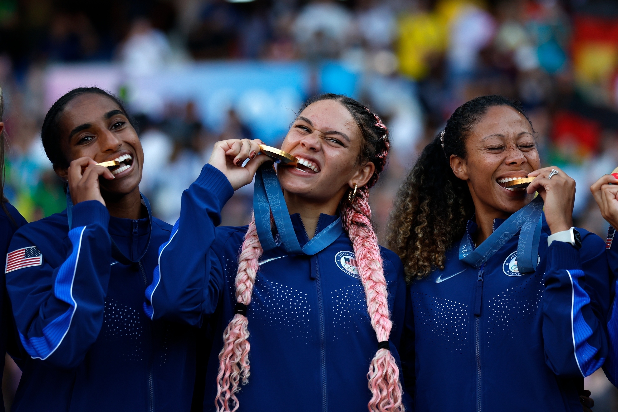 Trinity Rodman of the United States, center, and teammates bite their gold medals during the medal ceremony after the womens soccer gold medal match between Brazil and the United States at the Parc des Princes during the 2024 Summer Olympics, Saturday, Aug. 10, 2024, in Paris, France.