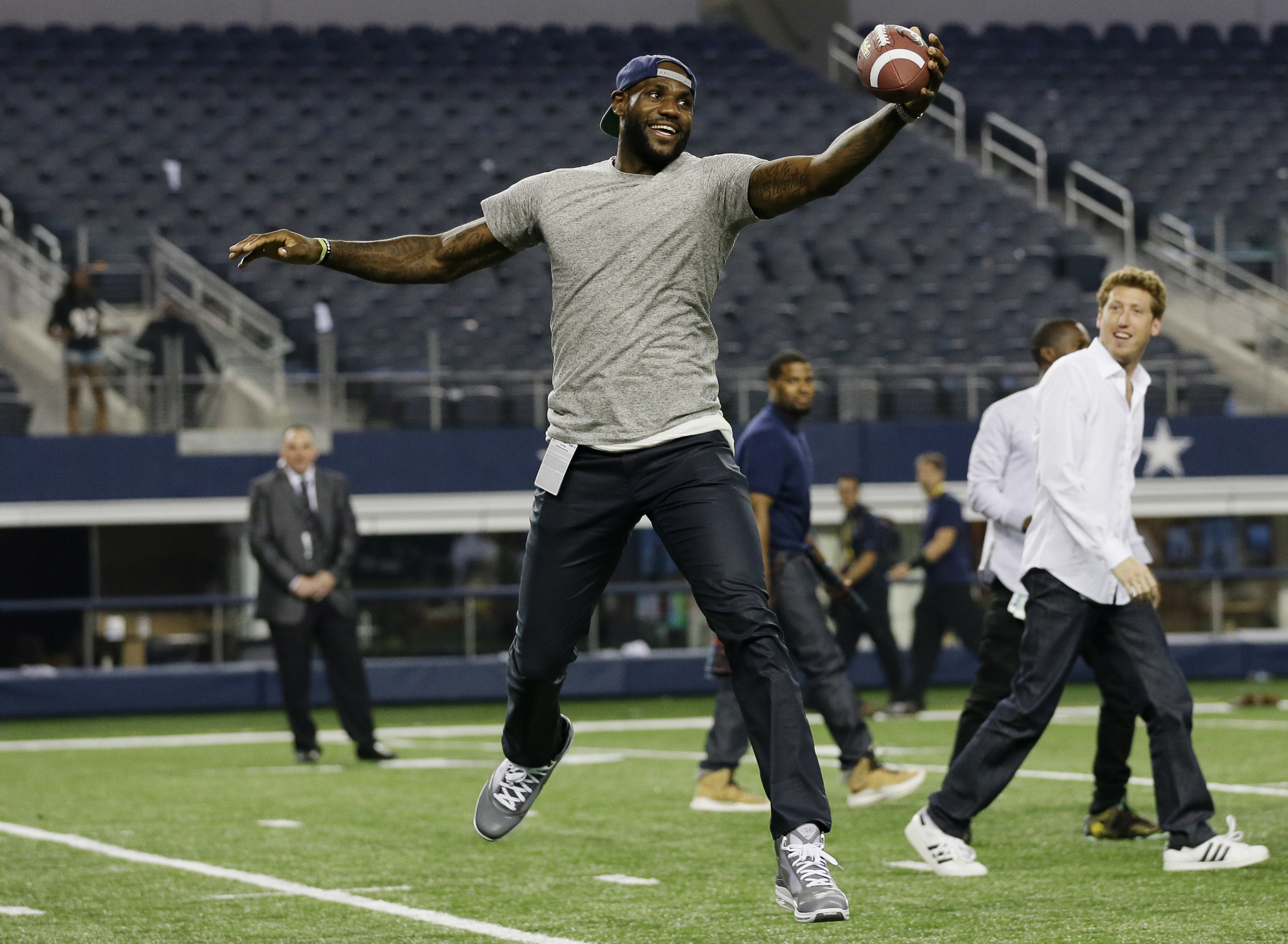 LeBron James plays pick-up football on the Dallas Cowboys field after an NFL football game