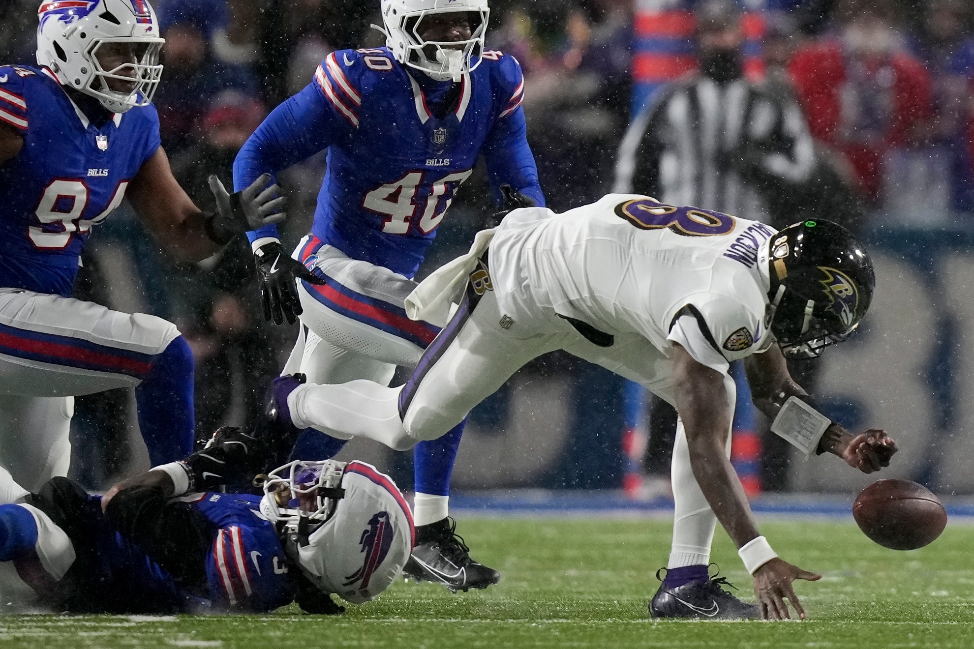 Baltimore Ravens quarterback Lamar Jackson (8) fumbles the ball as he is tackled by Buffalo Bills safety Damar Hamlin (3) during the second quarter of an NFL divisional playoff football game, Sunday, Jan. 19, 2025, in Orchard Park, N.Y.